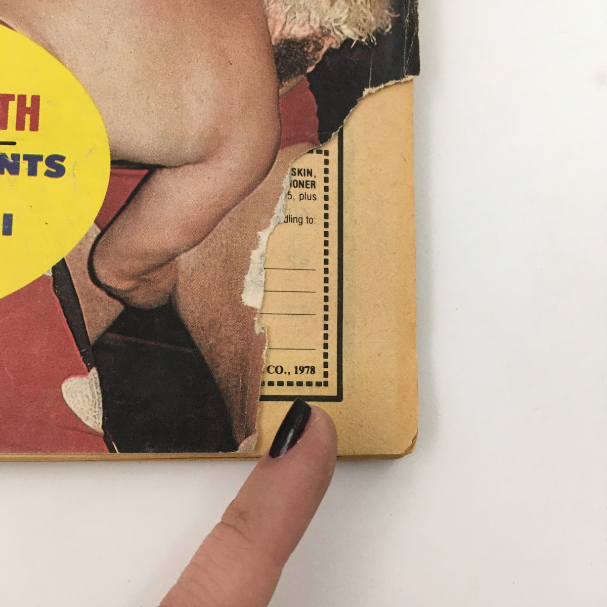 Detail of the edge of Wrestling Superstars Magazine Spring 1980 showing wear typical of vintage magazines with a torn corner.