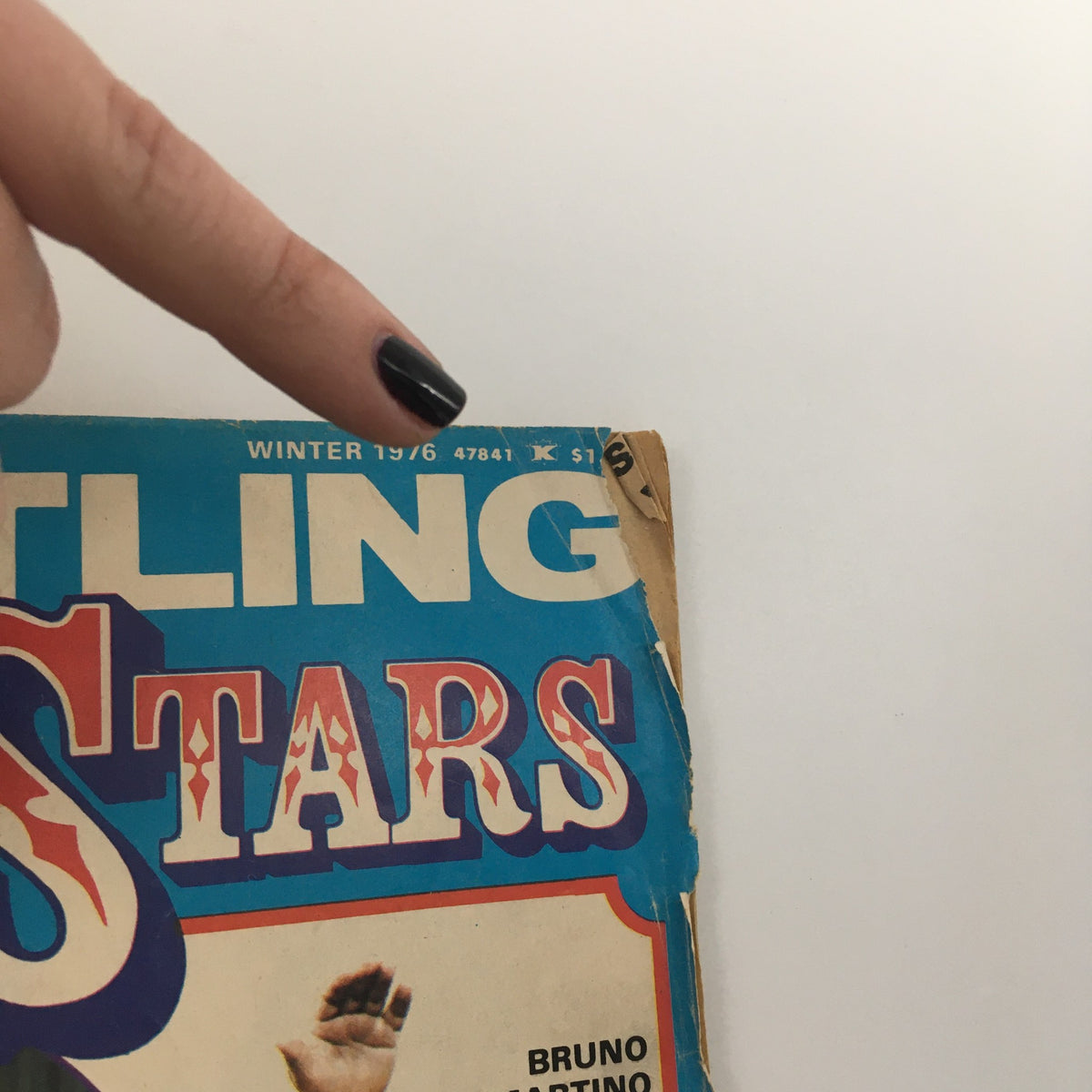 Cover of Wrestling Super Stars Magazine Winter 1976, displaying the title and a pointer indicating the date and price on the damaged corner.