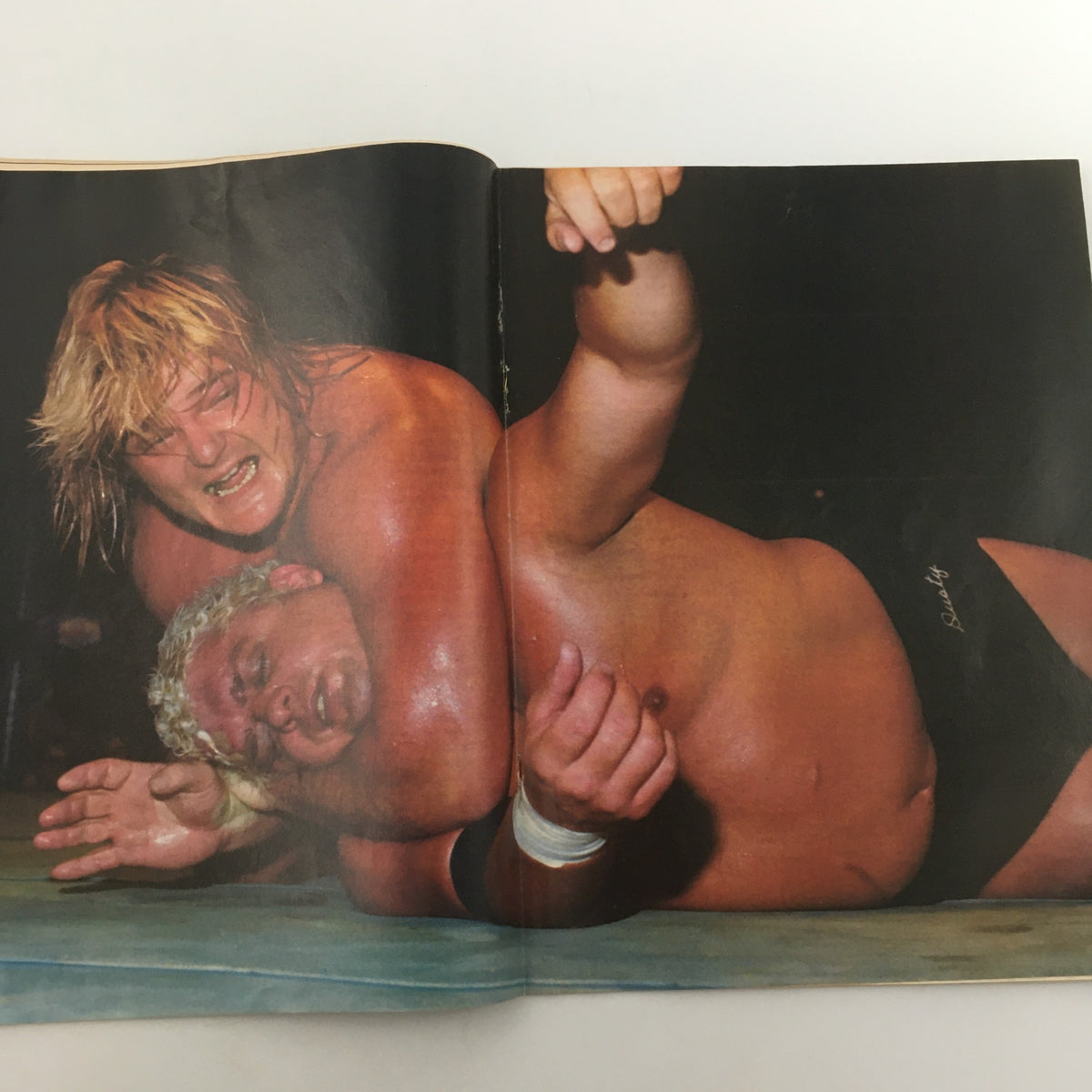 Inside spread of Wrestling's Main Event Magazine June 1982 showcasing a wrestling match, emphasizing the thrilling action of professional wrestling.