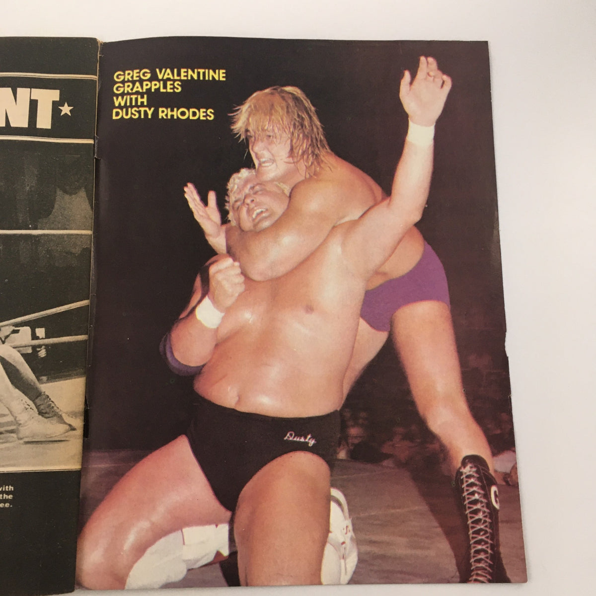 A dynamic wrestling scene from Wrestling World Magazine 1982 showing Greg Valentine grappling with Dusty Rhodes in an intense match, capturing the era's wrestling action.