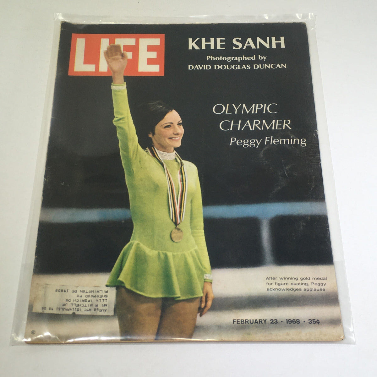 VTG Life Magazine: February 23 1968 featuring Olympic charmer Peggy Fleming in a figure skating outfit, showcasing her gold medal and smiling as she acknowledges applause.
