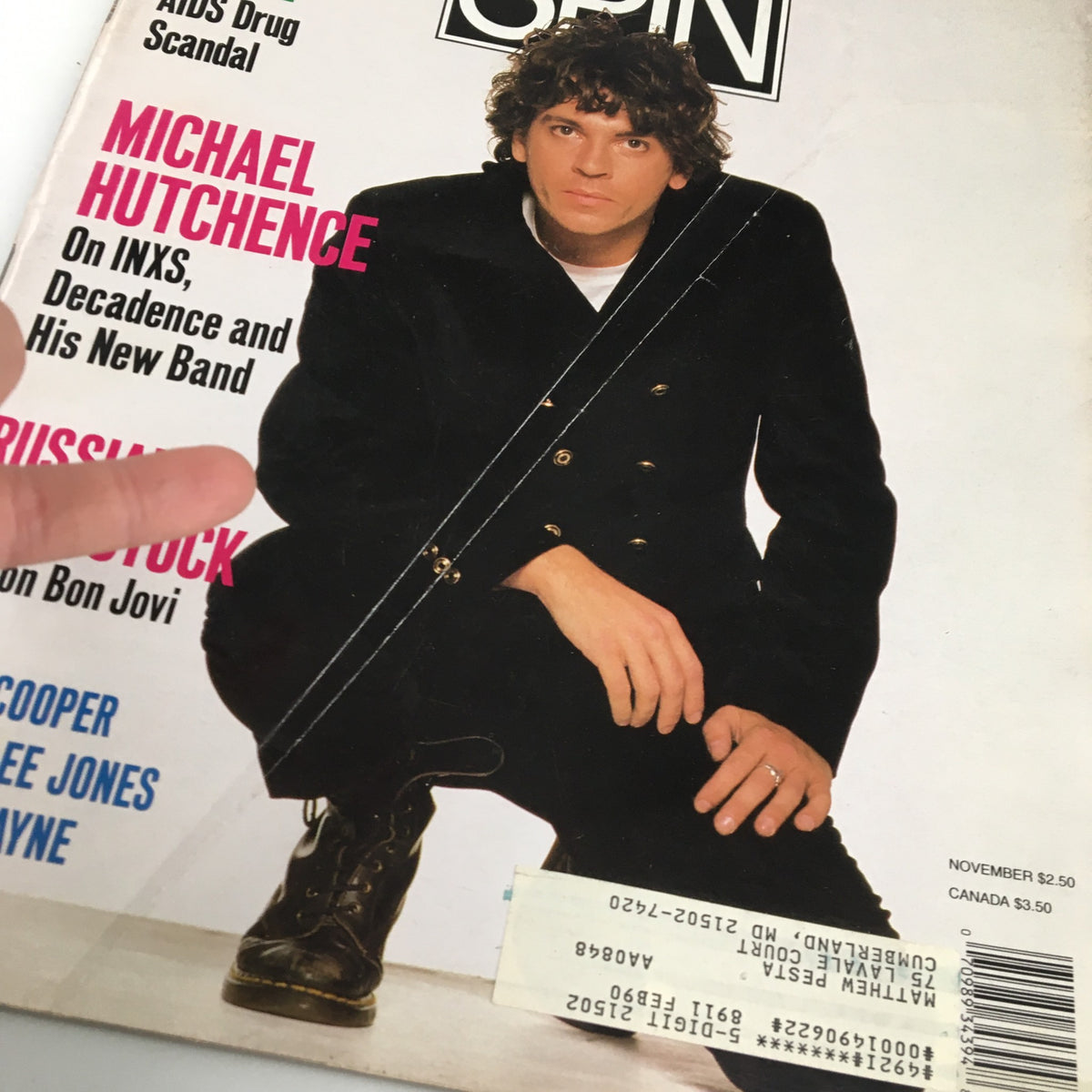 Close-up view of the cover of Spin Magazine November 1989 Volume 5 Issue 8, showcasing Michael Hutchence and key articles on music history.