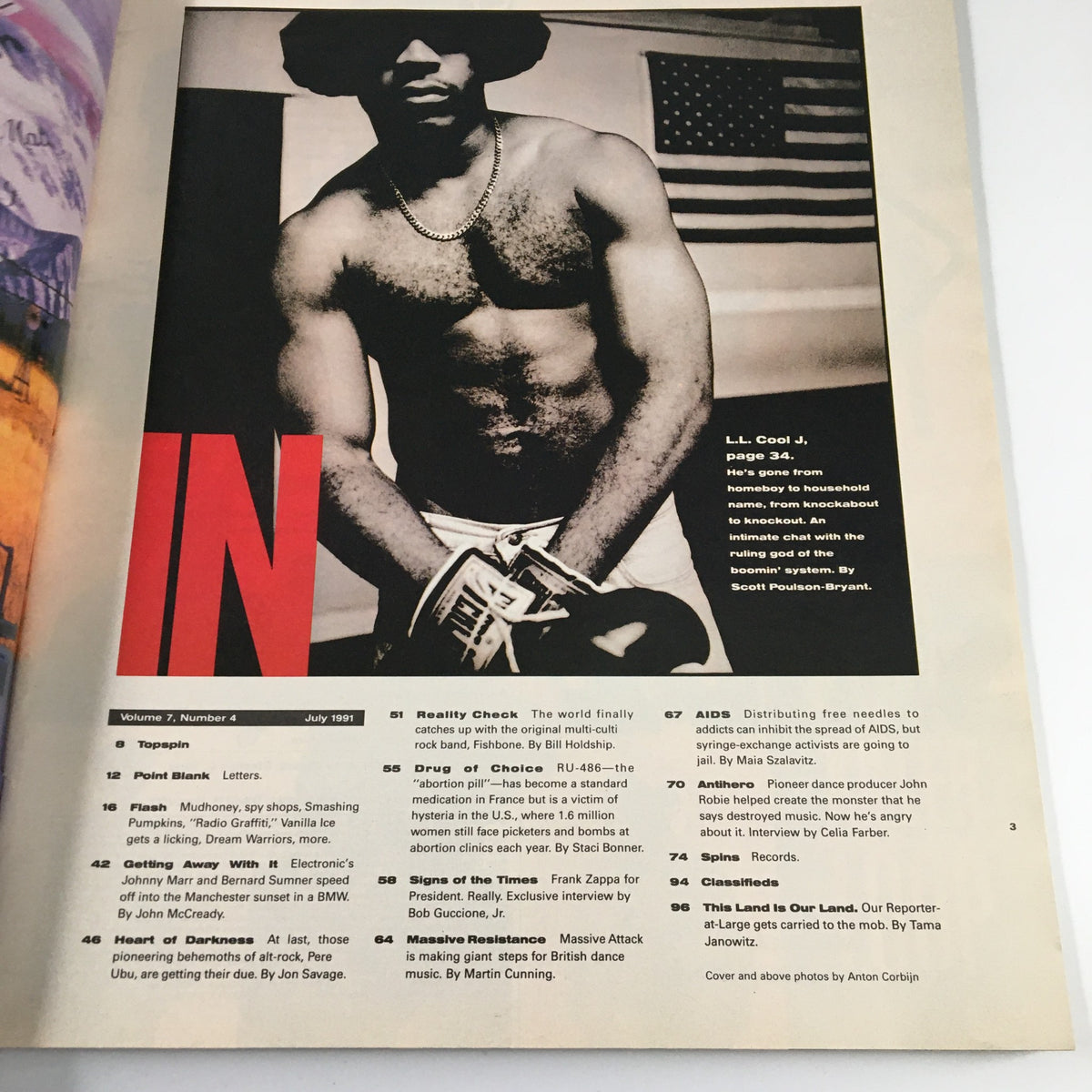 Inside page of Spin Magazine July 1991, Volume 7, Number 4 featuring an article about LL Cool J, highlighting his transformation and impact in a black and white photo against an American flag.