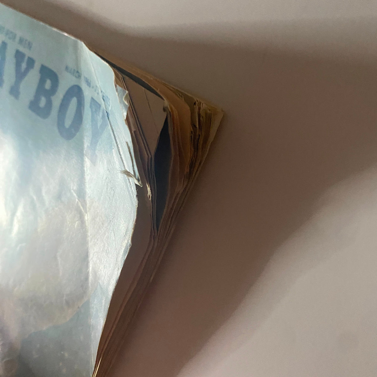 Spine view of Playboy Magazine March 1966, revealing wear and tear typical for vintage magazines, highlighting its collectible condition as part of pop culture history.