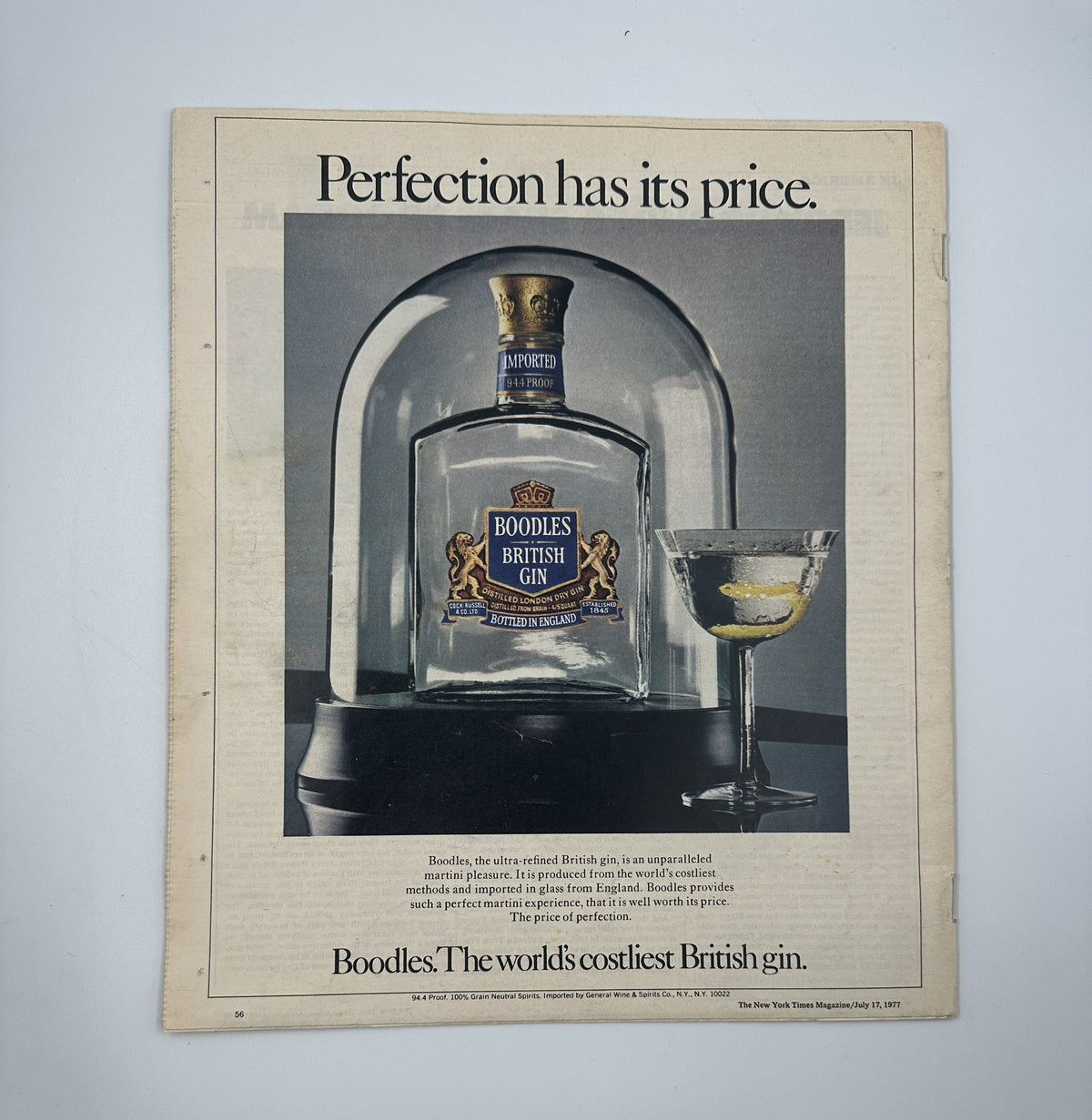 The New York Times Magazine July 17, 1977 advertisement for Boodles British Gin, showcasing the bottle under a glass dome with a cocktail glass beside it, emphasizing the tagline 'Perfection has its price'.