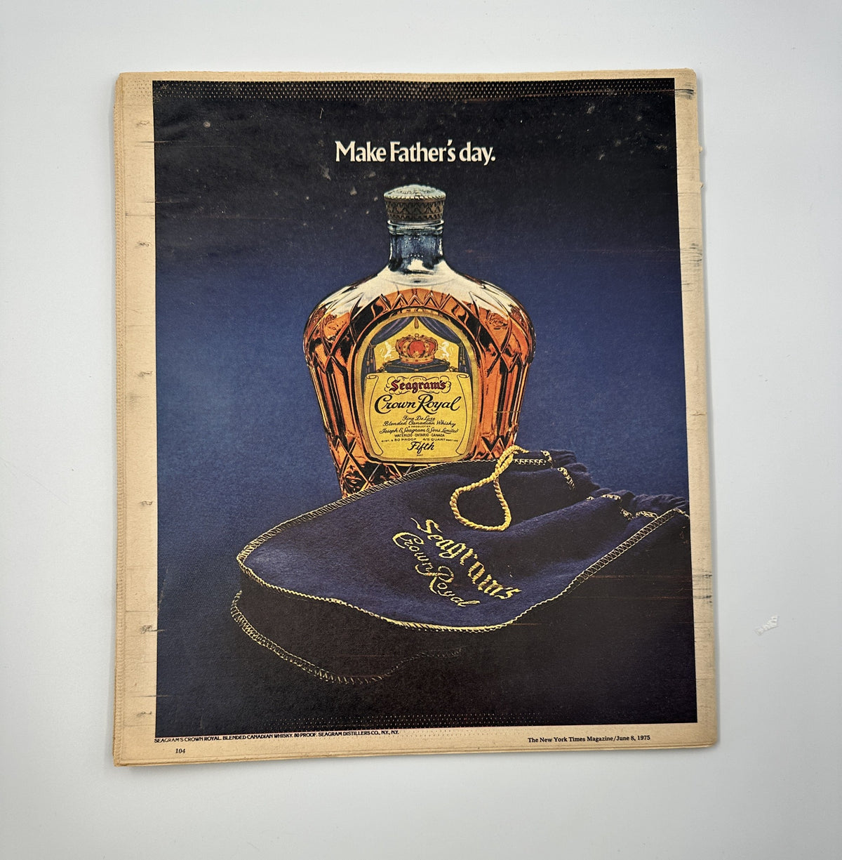 The New York Times Magazine June 8, 1975 advertisement for Crown Royal showcasing a whiskey bottle and a blue velvet bag with the text 'Make Father's day'.