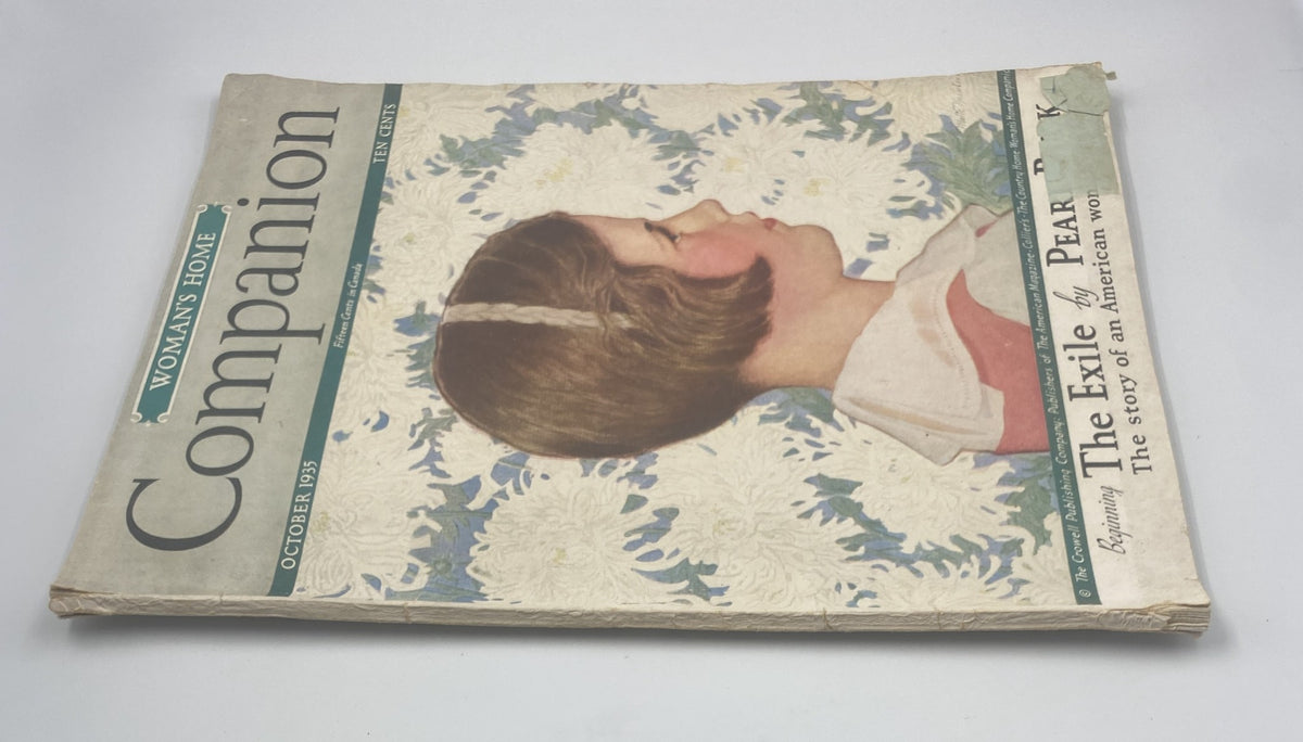 Close-up view of the October 1935 Woman’s Home Companion Magazine showing the cover art and title featuring 'The Exile by Pearl Buck.' Cover shows signs of wear.