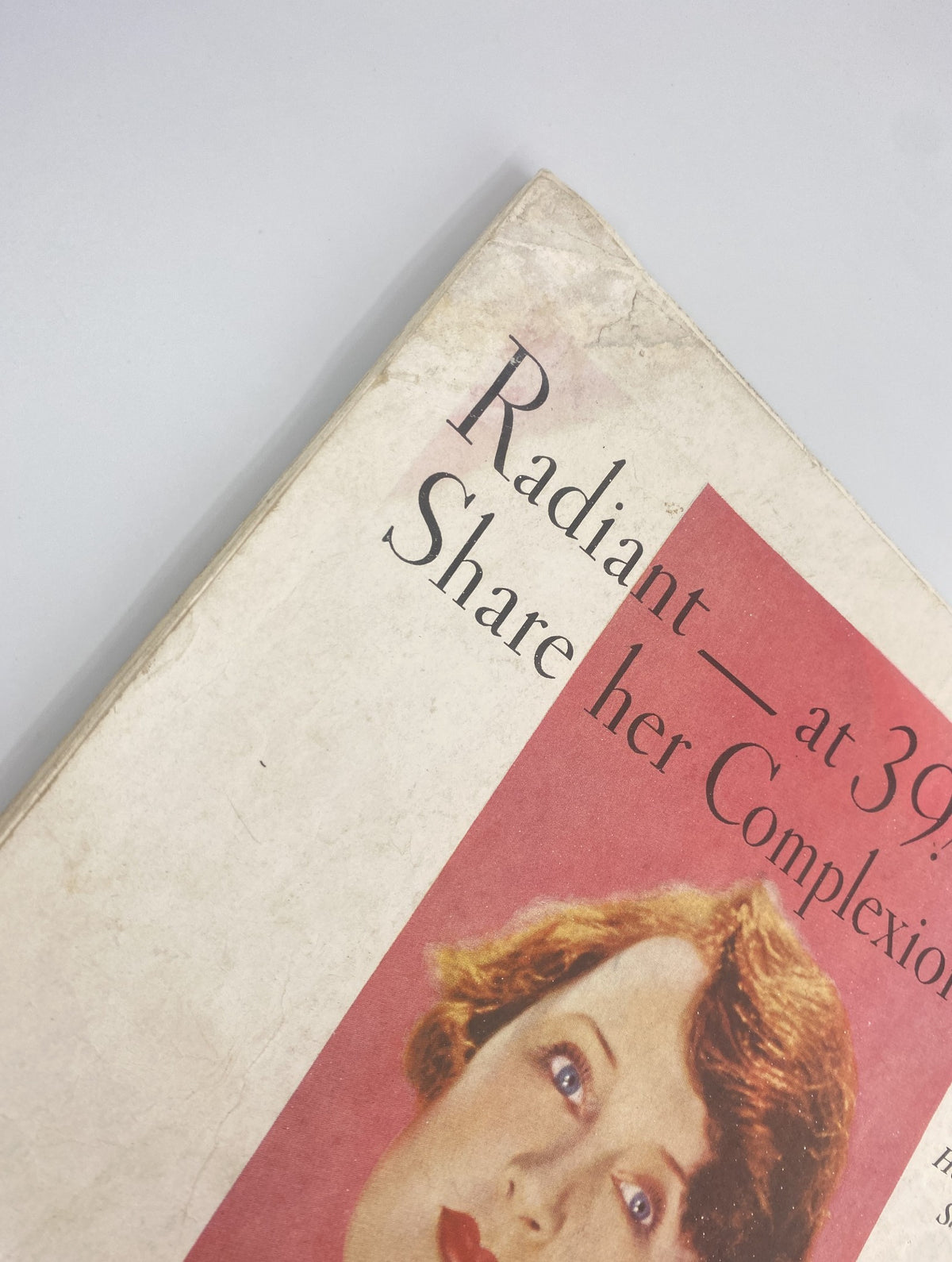 Close-up of the spine of Woman’s Home Companion Magazine July 1932, showing the magazine title with a model's face.