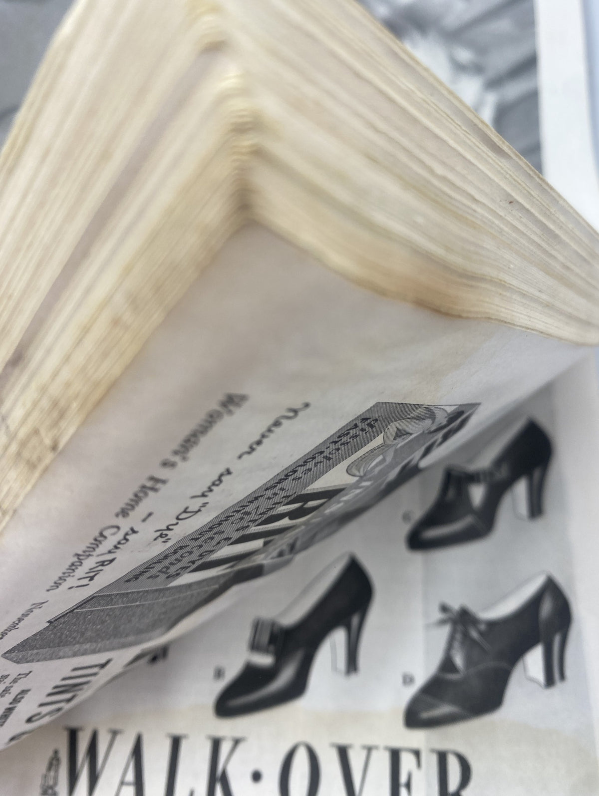 Top view of pages from Woman’s Home Companion Magazine November 1936 displaying aged paper edges and an advertisement for shoes.