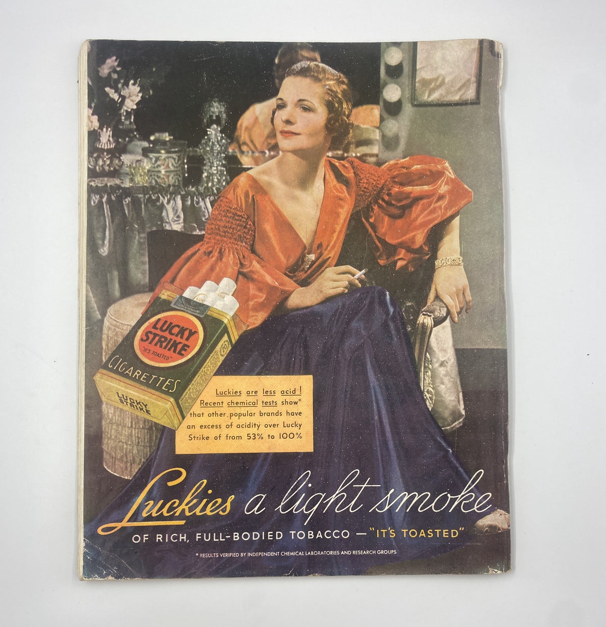 Cover page of Woman’s Home Companion Magazine, April 1936, featuring a glamorous woman in a blue dress with an advertisement for Lucky Strike cigarettes.