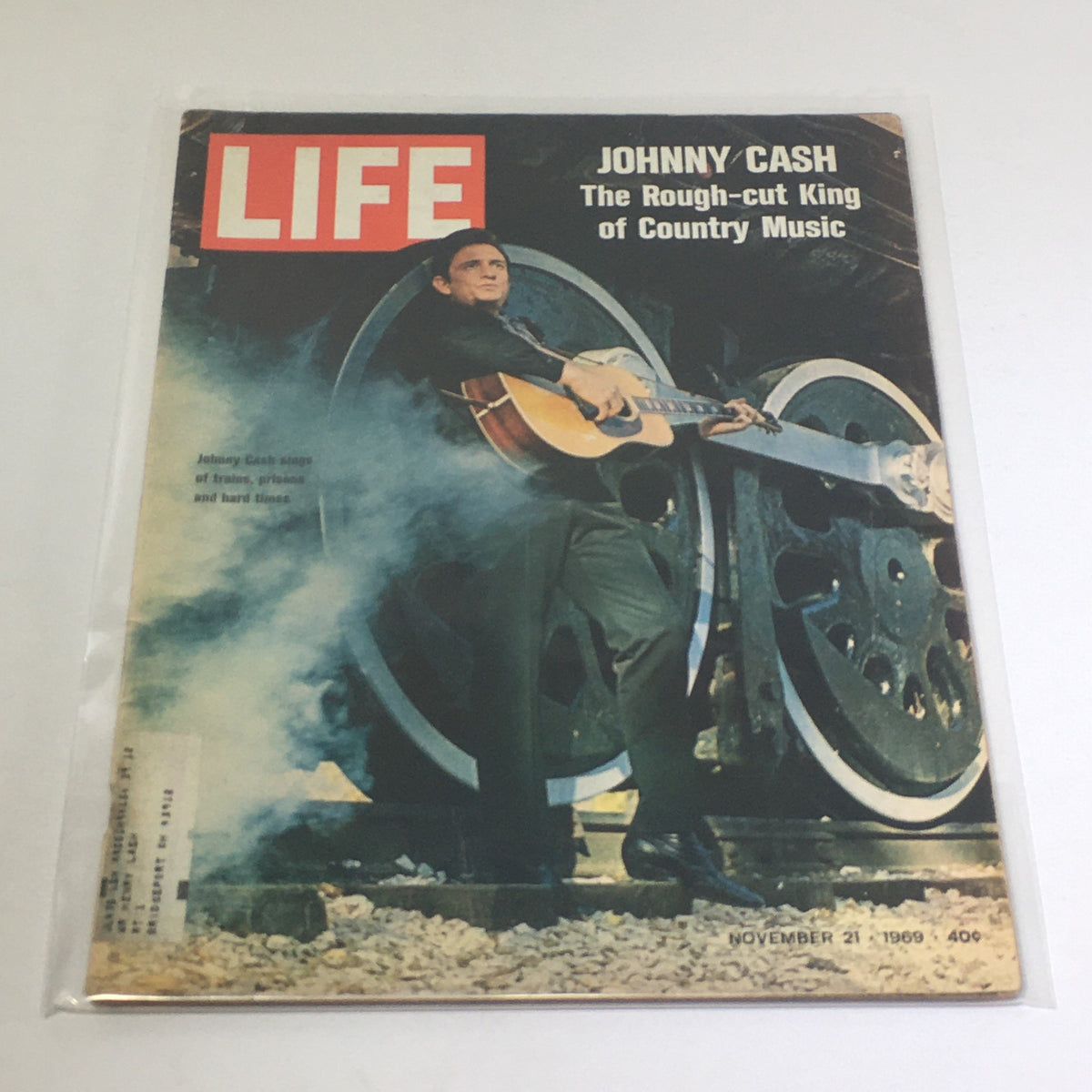 Vintage Life Magazine featuring Johnny Cash on the cover, titled 'Johnny Cash: The Rough-cut King of Country Music', dated November 21, 1969, showcasing the legendary country artist with his guitar in front of large wheels.