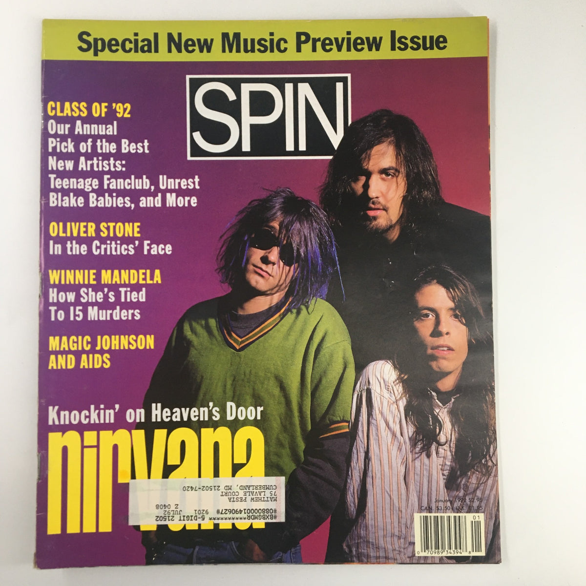 Cover of Spin Magazine January 1992 Vol 7 #10 featuring Nirvana, Oliver Stone, and Magic Johnson. The cover highlights 'Knockin' on Heaven's Door' and showcases a special music preview issue.