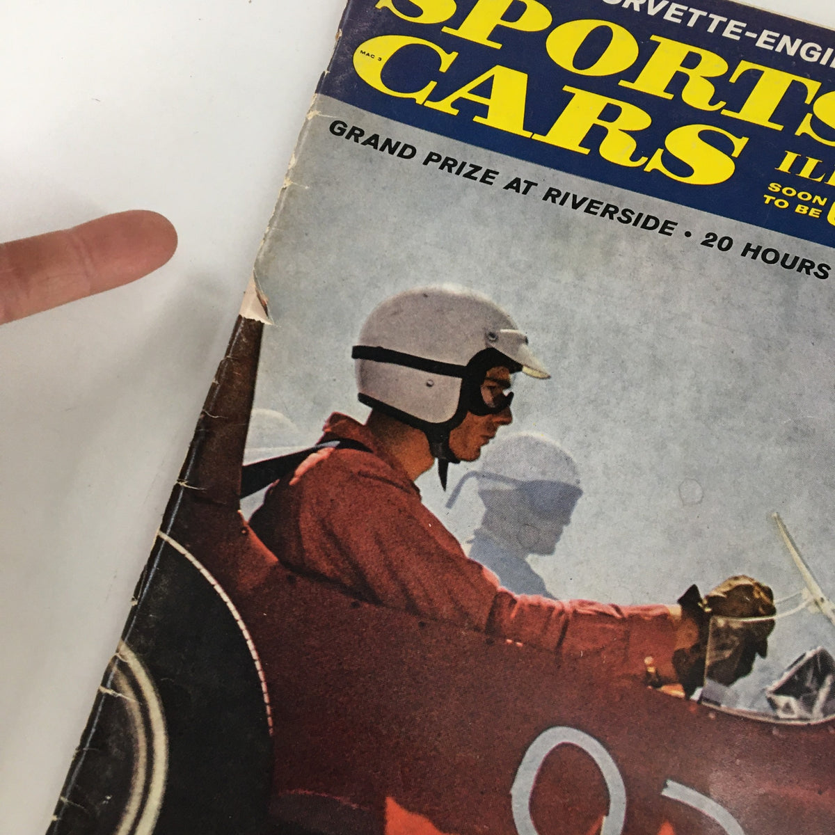 Close-up of the cover of Sports Car Illustrated Magazine March 1961, focusing on the Corvette-Engined Sting Ray with a detailed view of the magazine's title and design elements.