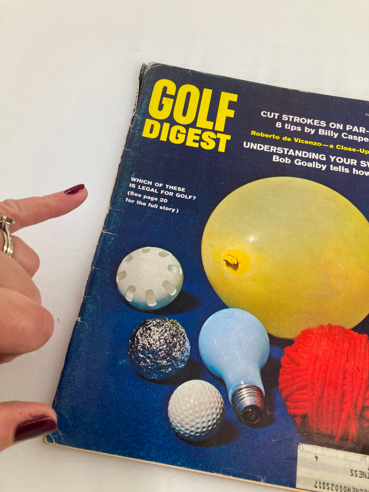 Close-up of the VTG Golf Digest Magazine July 1968 cover, highlighting various objects related to golf and the question of legality in the sport.