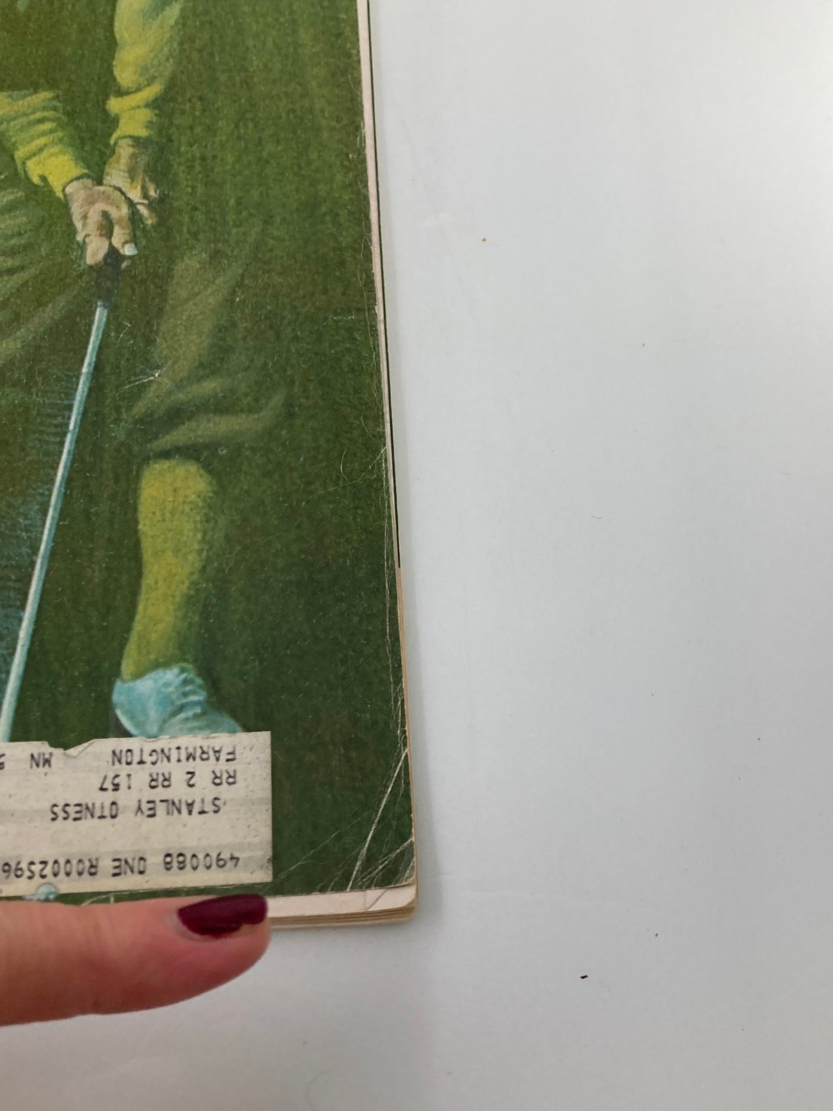 Close-up of the bottom corner of the August 1969 Golf Digest Magazine showing the label and age-related wear.