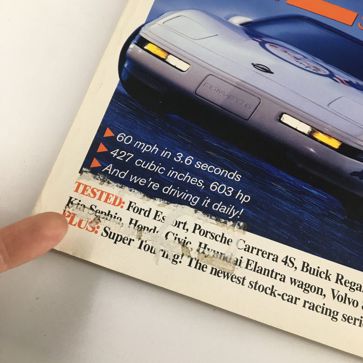 Close-up of the Car and Driver Magazine June 1996 cover highlighting tested cars and performance stats including Ford Escort and Porsche Carrera 4S.