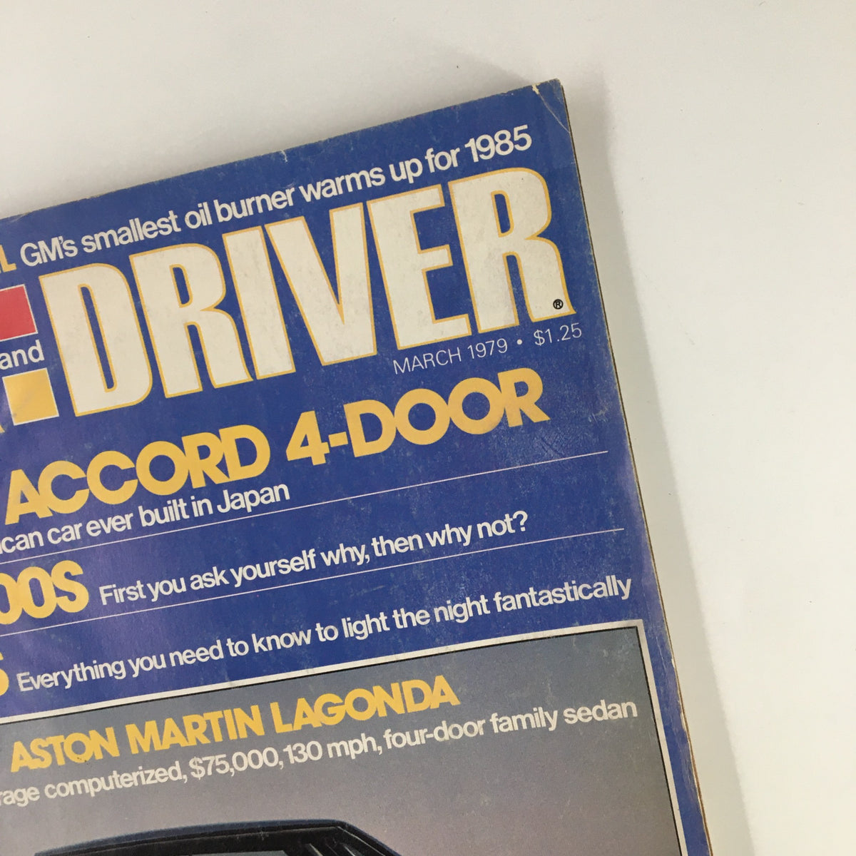 Detailed view of the top section of Car and Driver Magazine March 1979 cover, featuring headlines about the Honda Accord and Aston Martin Lagonda, emphasizing car culture in the 1970s.