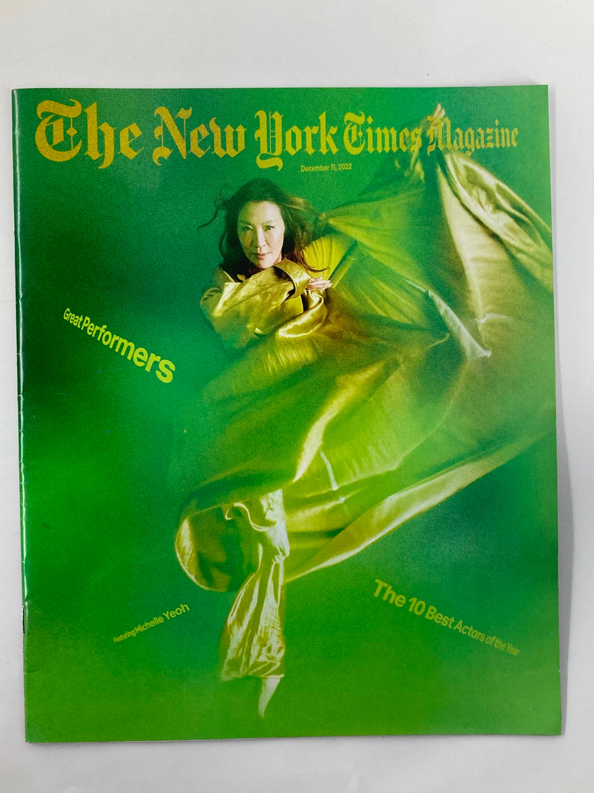 The New York Times Magazine cover from December 11, 2022, featuring Michelle Yeoh in a striking green background, showcasing her as one of the great performers and highlighting the top actors of the year.