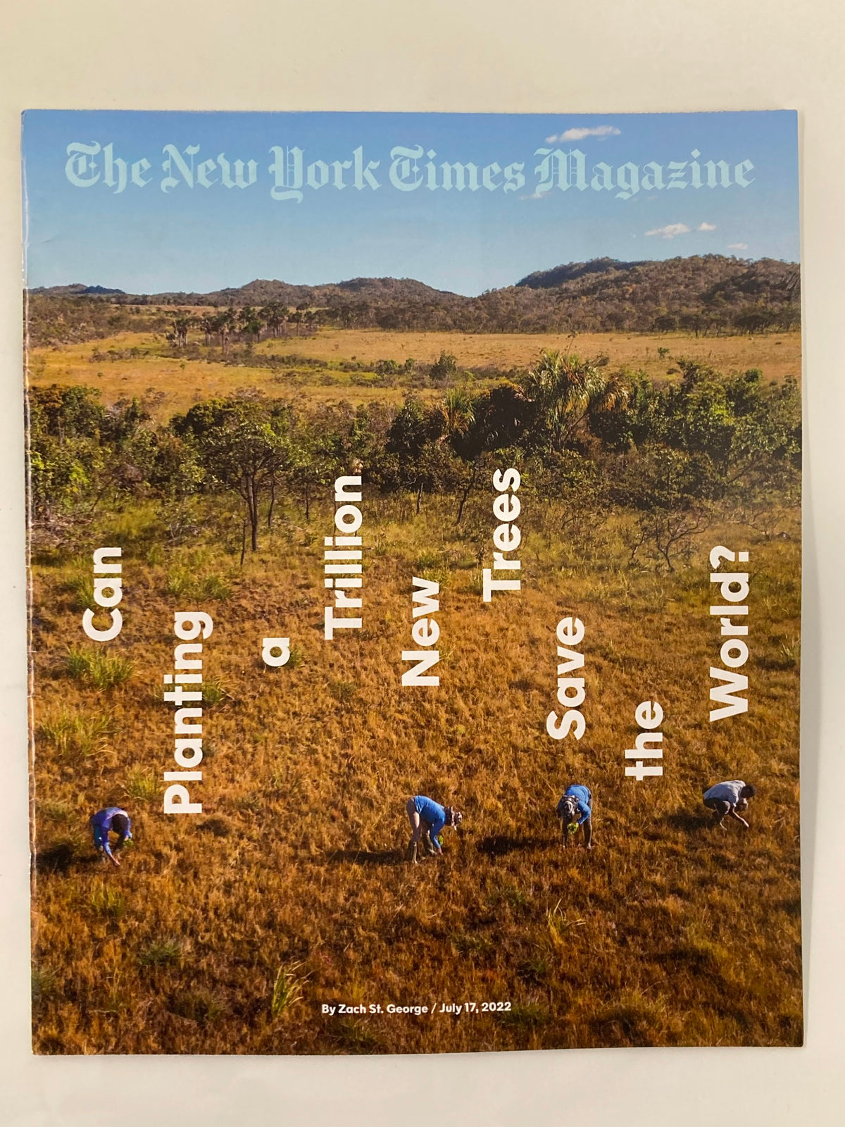 Cover of The New York Times Magazine July 17 2022 depicting individuals planting trees in a vibrant landscape, with the question 'Can Planting a Trillion New Trees Save the World?' prominently featured.
