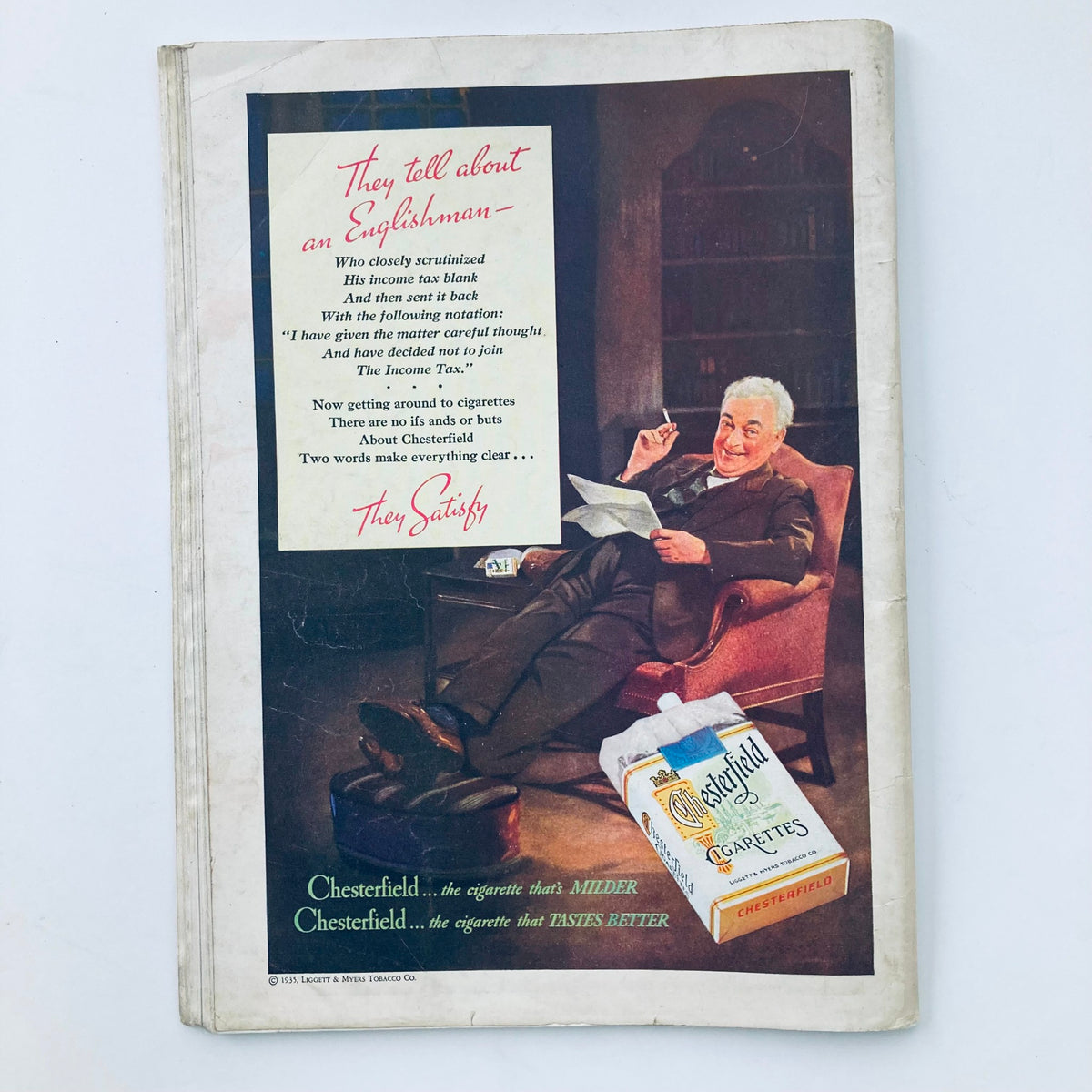 Vintage Time Magazine October 21, 1935 Vol 26 No. 17 featuring an advertisement for Chesterfield cigarettes, showcasing a relaxed man reading in a cozy setting, emphasizing the brand's slogan 'They Satisfy'.
