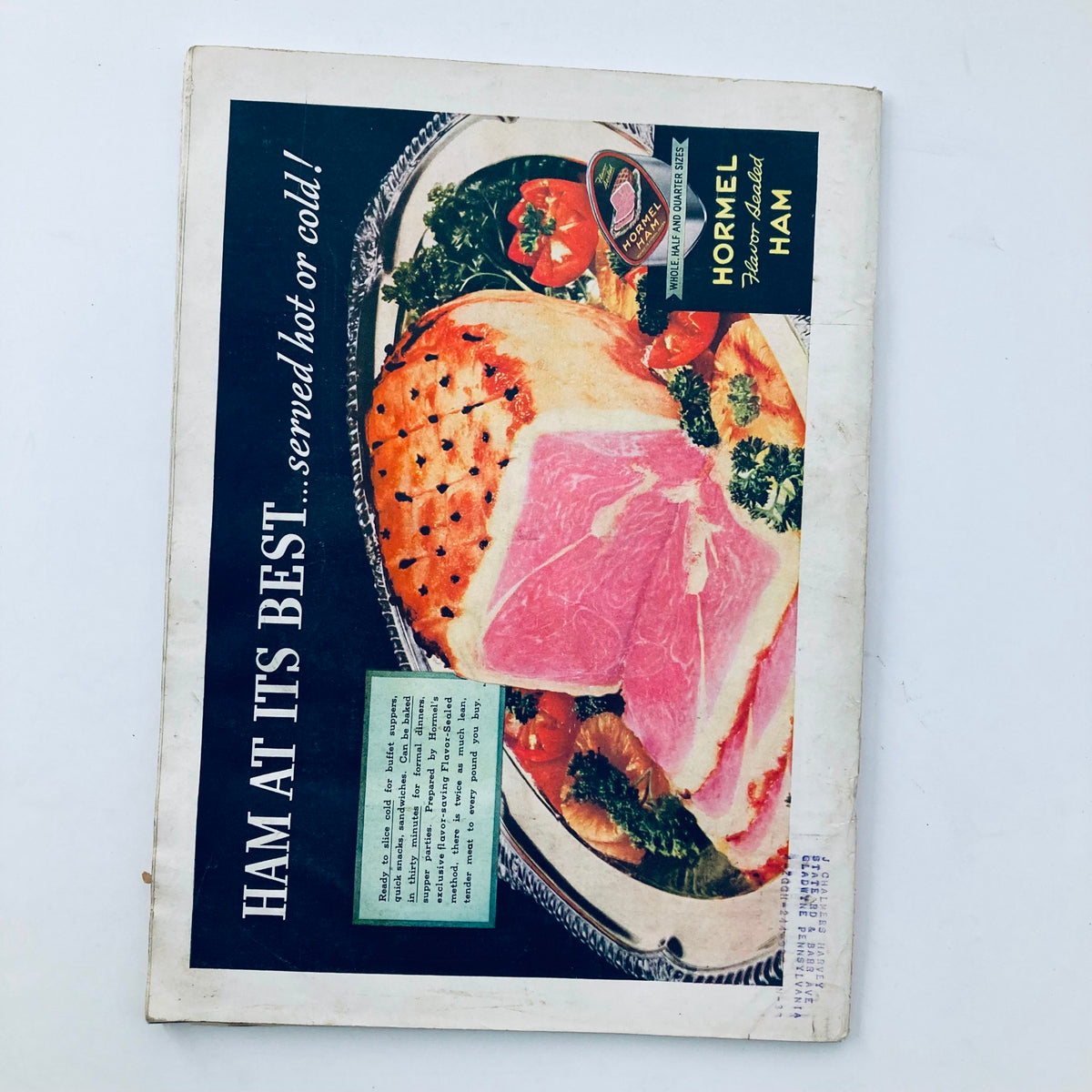 Vintage advertisement for Hormel ham, displaying a luxurious platter with ham and vegetables, emphasizing the quality and presentation, suitable for collection.