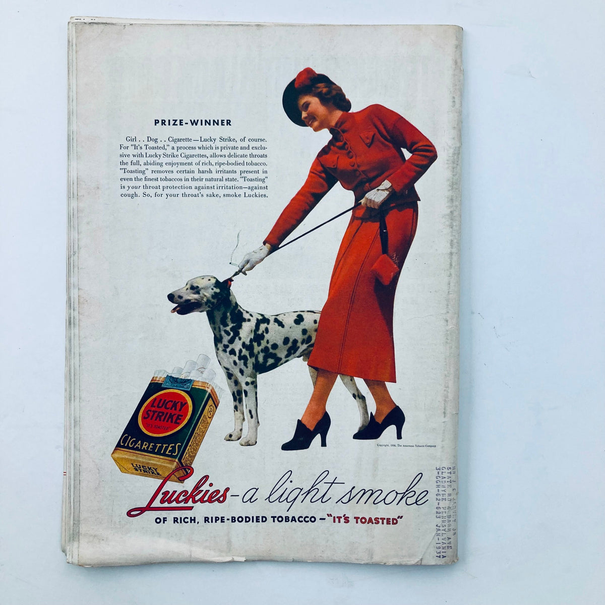 Advertisement page from the November 2, 1936 Time Magazine featuring a woman in a red outfit and a Dalmatian dog promoting Lucky Strike cigarettes.