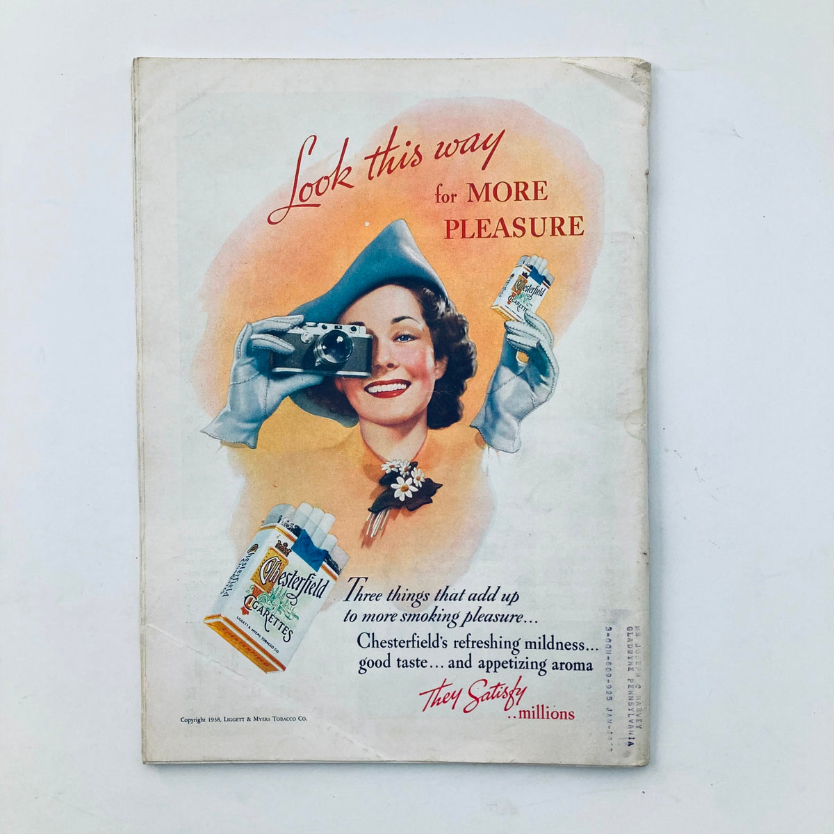 Vintage advertisement featured in VTG Time Magazine April 4 1938 Vol 31 No. 14 showcasing a woman taking a photograph while promoting Chesterfield cigarettes with the tagline 'Look this way for MORE PLEASURE.' This historical piece reflects advertising styles from the 1930s.
