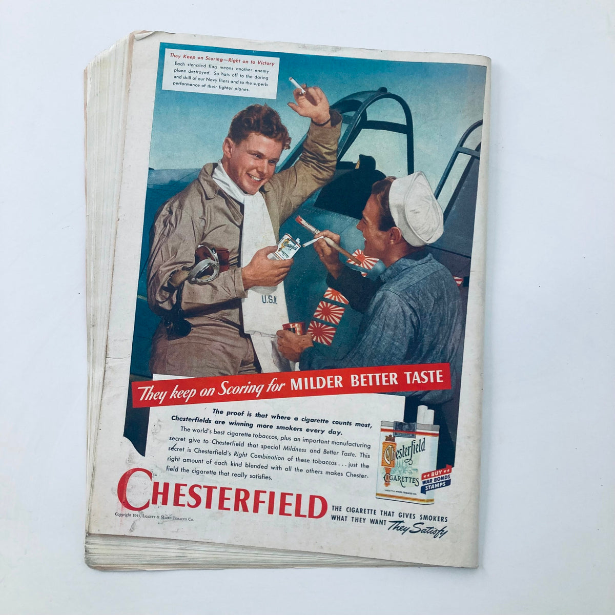 Vintage advertisement from VTG Time Magazine July 19 1943 for Chesterfield cigarettes, featuring two men enjoying the product amidst a wartime theme.