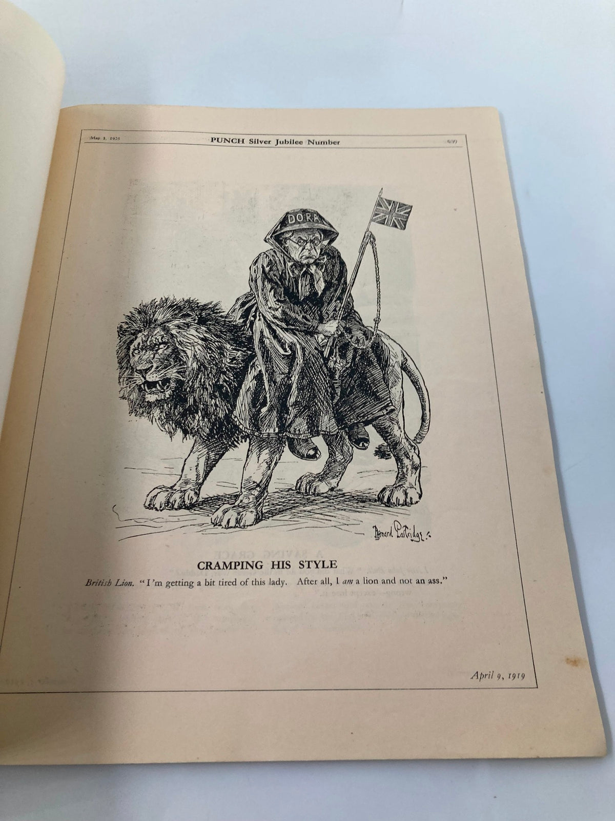 Humorous cartoon page from VTG Punch Magazine May 1 1935, portraying a British lion in a comical situation with a lady, titled 'Cramping His Style'.