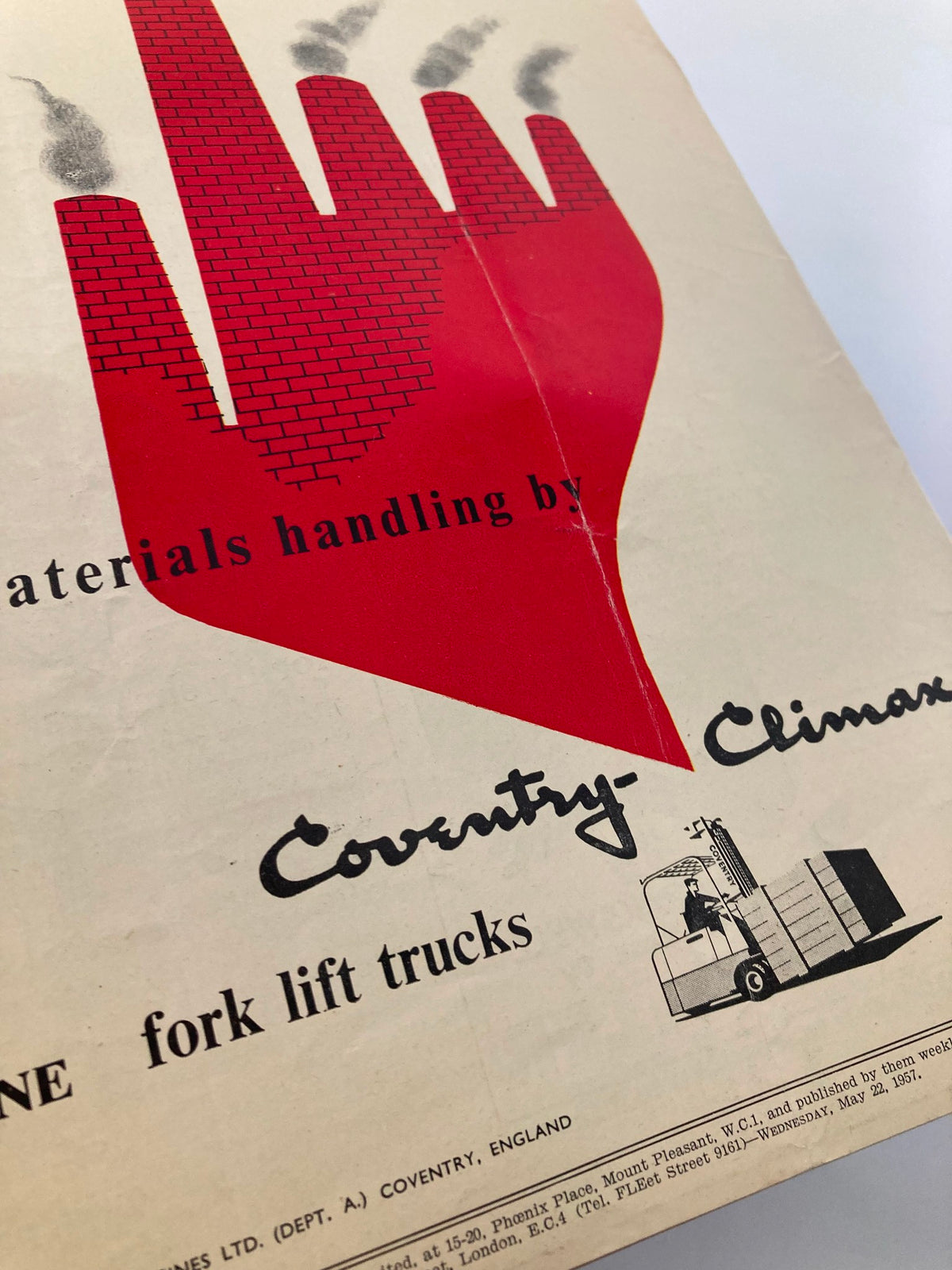 Advertisement from VTG Punch Magazine May 22 1957 presenting materials handling solutions by Coventry-Climax, featuring a bold graphic design of a red hand silhouette with a fork lift truck illustration.