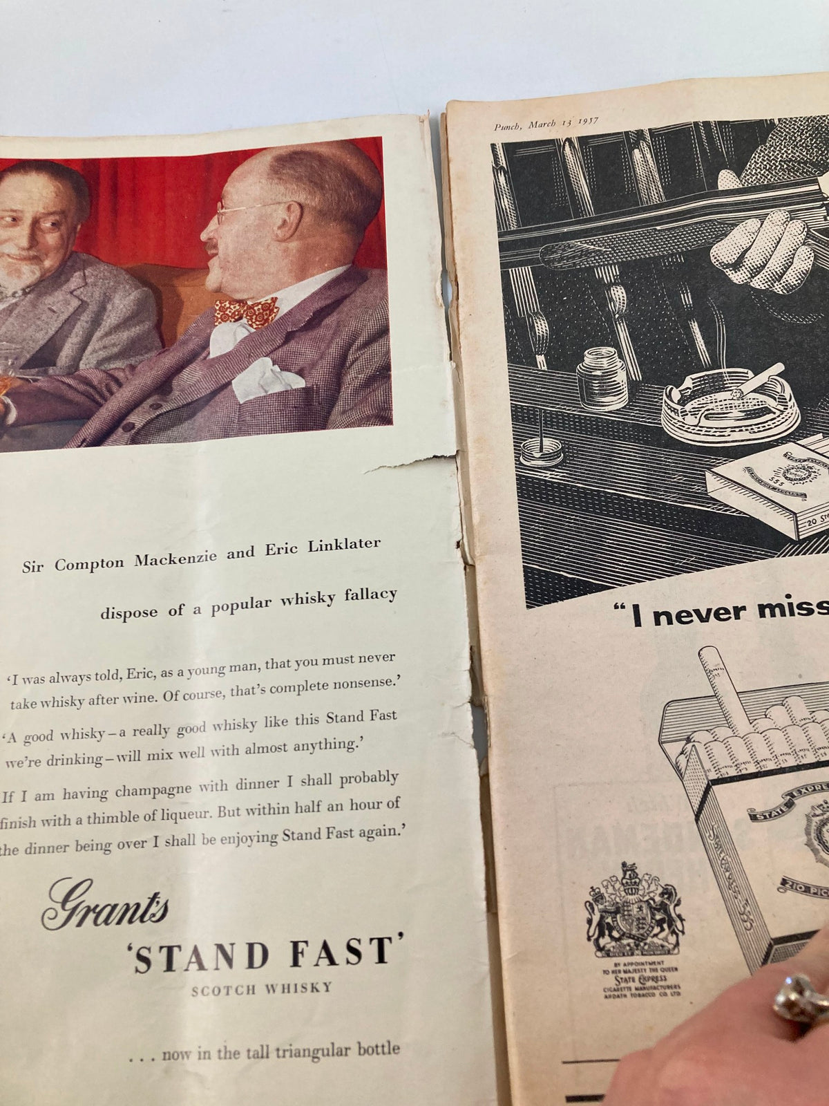 Interior page of VTG Punch Magazine from March 13, 1957 showing a conversation between Sir Compton Mackenzie and Eric Linklater about whisky, along with an advertisement for Grant's Stand Fast Scotch Whisky.