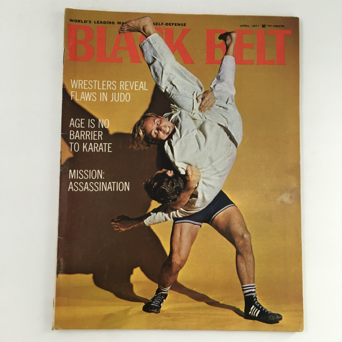 Cover of Black Belt Magazine April 1971 featuring an action-packed image of wrestlers revealing flaws in judo techniques, highlighting the intricate dynamics of martial arts with the caption 'Wrestlers Reveal Flaws in Judo' and promoting articles on karate and martial arts.