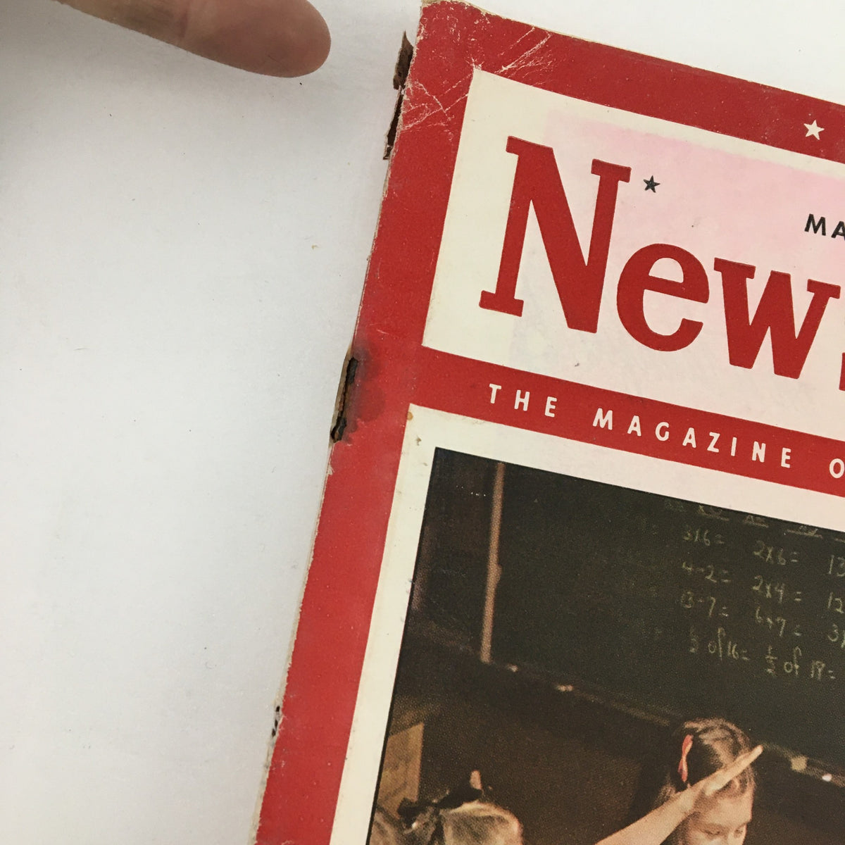 Close-up of the side of the Newsweek Magazine cover from March 17, 1947, showing the title and part of the classroom scene in the background.