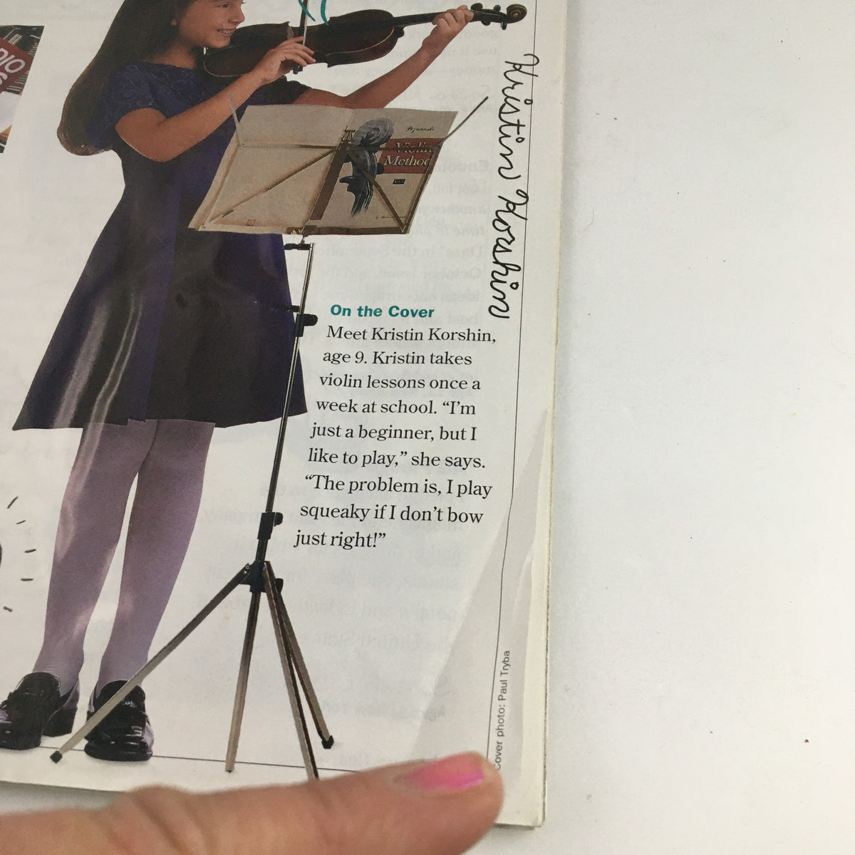 Close-up of the cover of American Girl Magazine January February 1998 with Kristin Korshin, age 9, practicing violin. The text discusses her lessons and experiences, emphasizing the magazine's focus on young girls' stories and creativity.