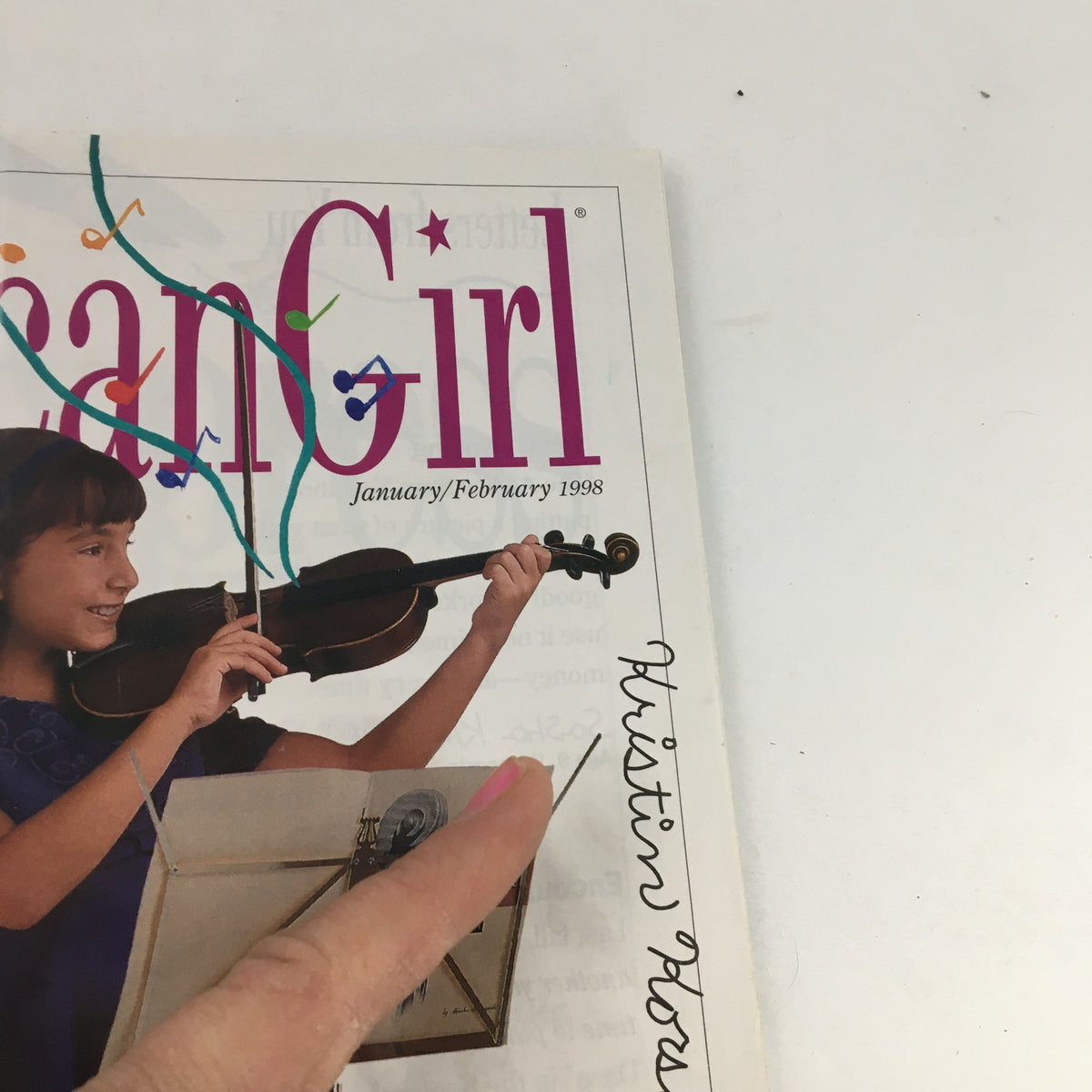 Cover of American Girl Magazine from January-February 1998 featuring Kristin Korshin with a violin. The magazine highlights creativity and adventure in a vintage format.
