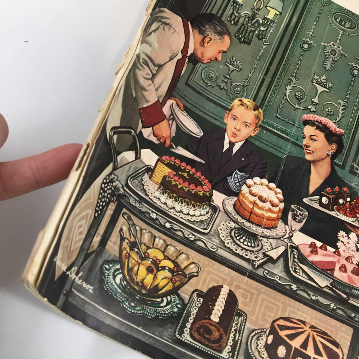 Vintage illustration of a dining scene from The Saturday Evening Post January 1 1955, showcasing a boy, a woman, and a waiter amidst a table full of cakes and desserts.