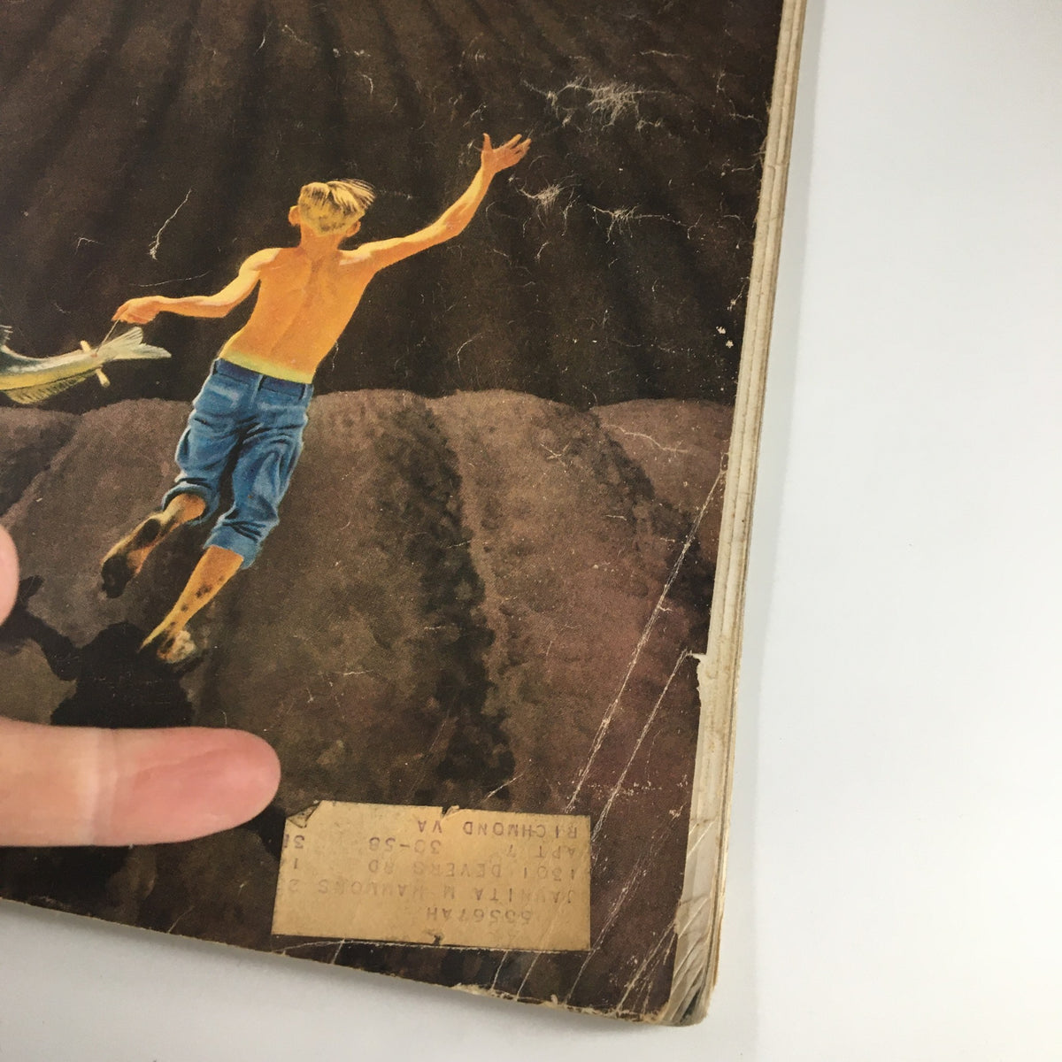 Close-up view of the cover of The Saturday Evening Post May 28, 1955, highlighting the illustration of a young boy with a fish, illustrating the nostalgic theme of childhood adventures.
