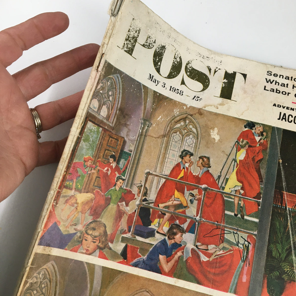 Side view of the cover of The Saturday Evening Post May 3 1958 showcasing the prominent title and illustrations, held in a hand for scale.