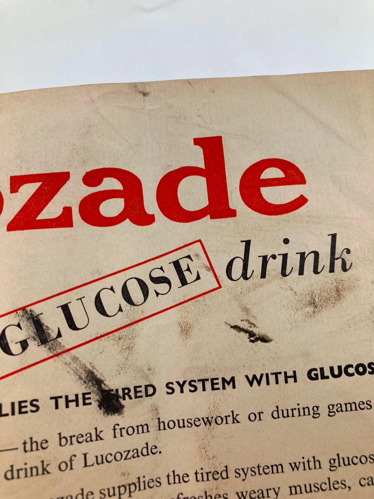 Close-up of vintage advertisement for Lucozade drink that supplies glucose, showcasing a small part of the content inside the VTG Punch Magazine from September 26, 1951.