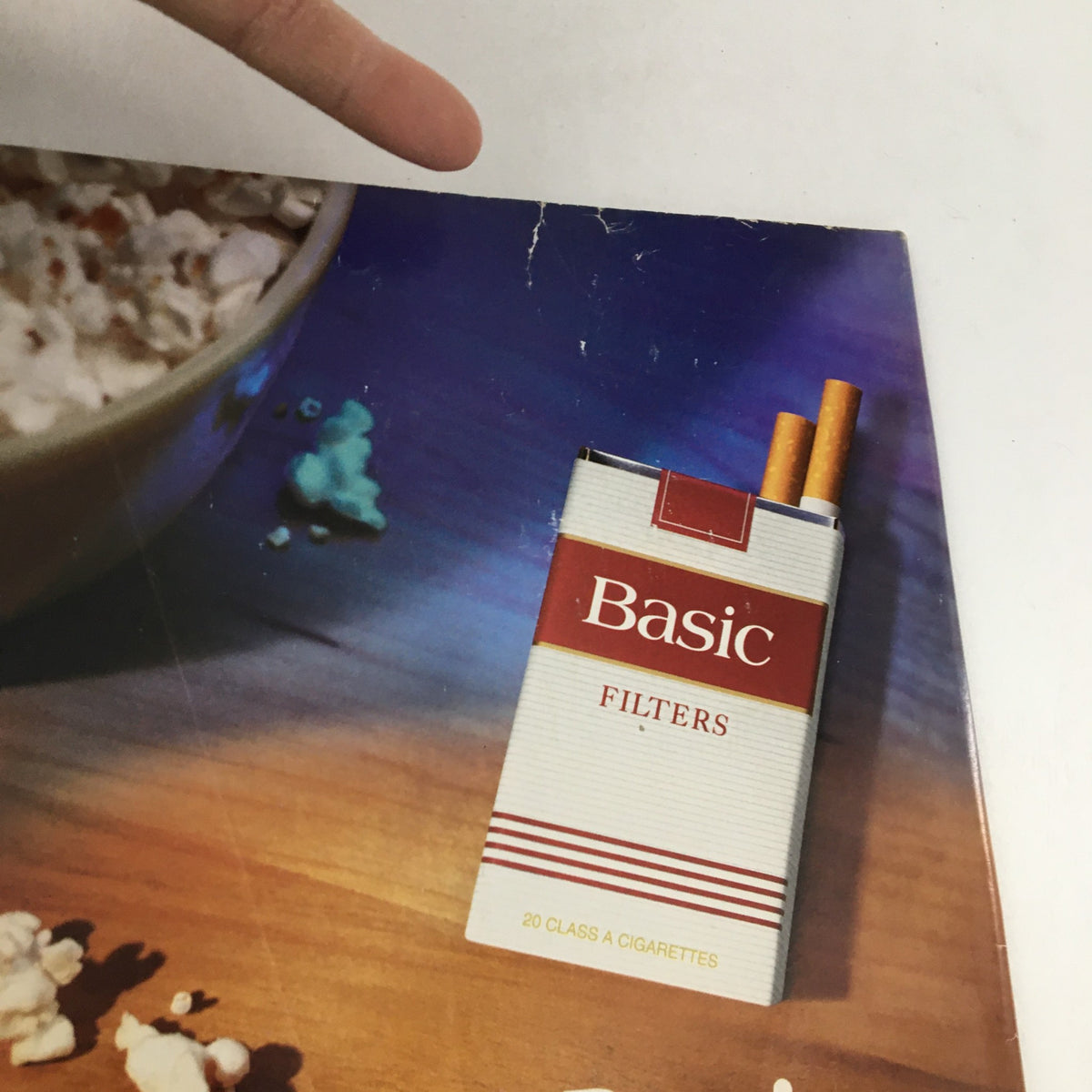 Close-up image of an advertisement for Basic Filters cigarettes on the back cover of Cycle World Magazine November 1997. Highlights vintage advertising style.