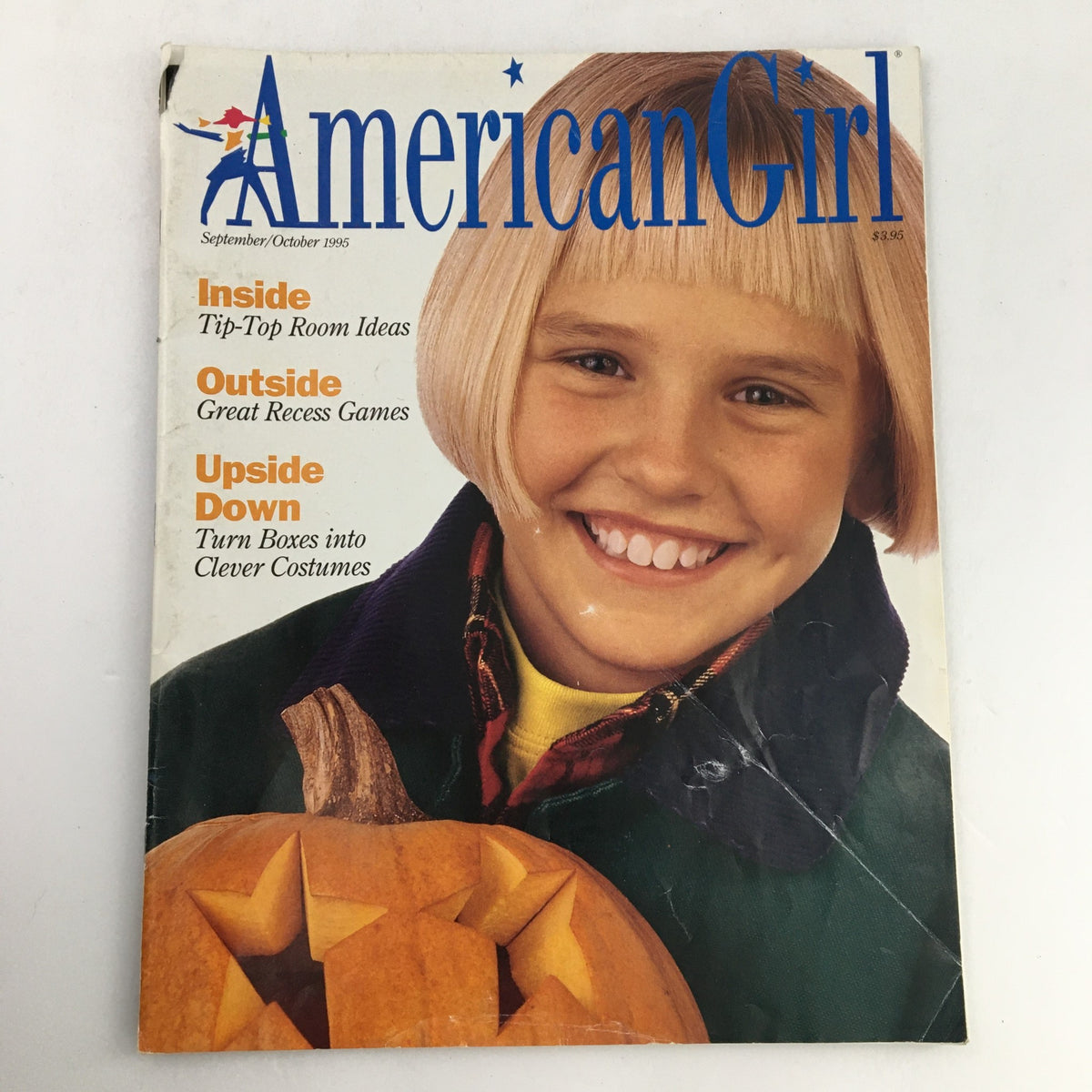 Cover of American Girl Magazine September-October 1995 featuring a smiling girl with a bowl haircut and a pumpkin, highlighting topics like great recess games and clever costumes.