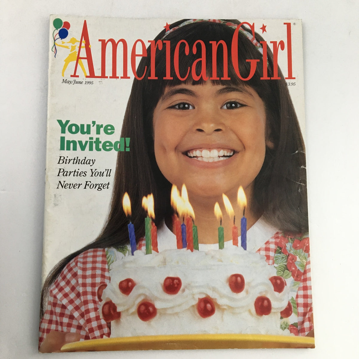Cover of American Girl Magazine May-June 1995 featuring a smiling girl with a birthday cake, celebrating unforgettable birthday parties.