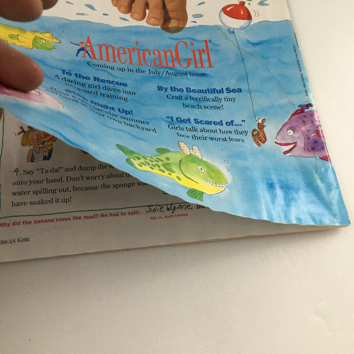 Detailed view of the back cover of American Girl Magazine May-June 1998 showing playful illustrations and a list of engaging topics for young readers.