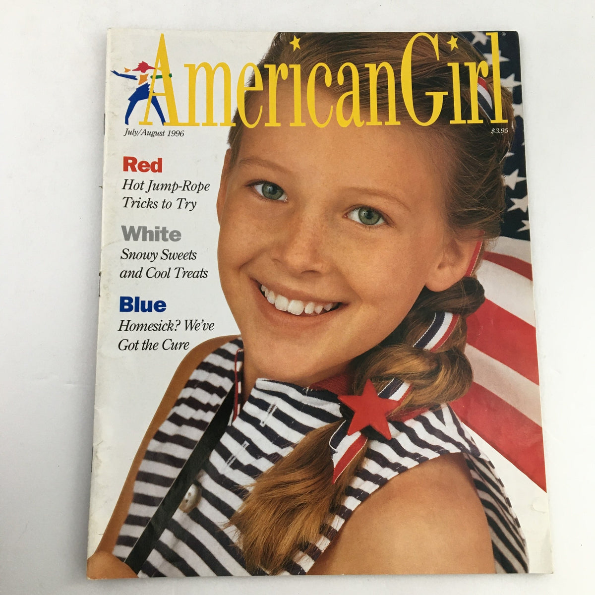 Cover of American Girl Magazine July-August 1996 featuring a smiling girl with freckles and braids, wearing a striped shirt adorned with a star clip, next to an American flag, highlighting snowy treats and jump-rope tricks.