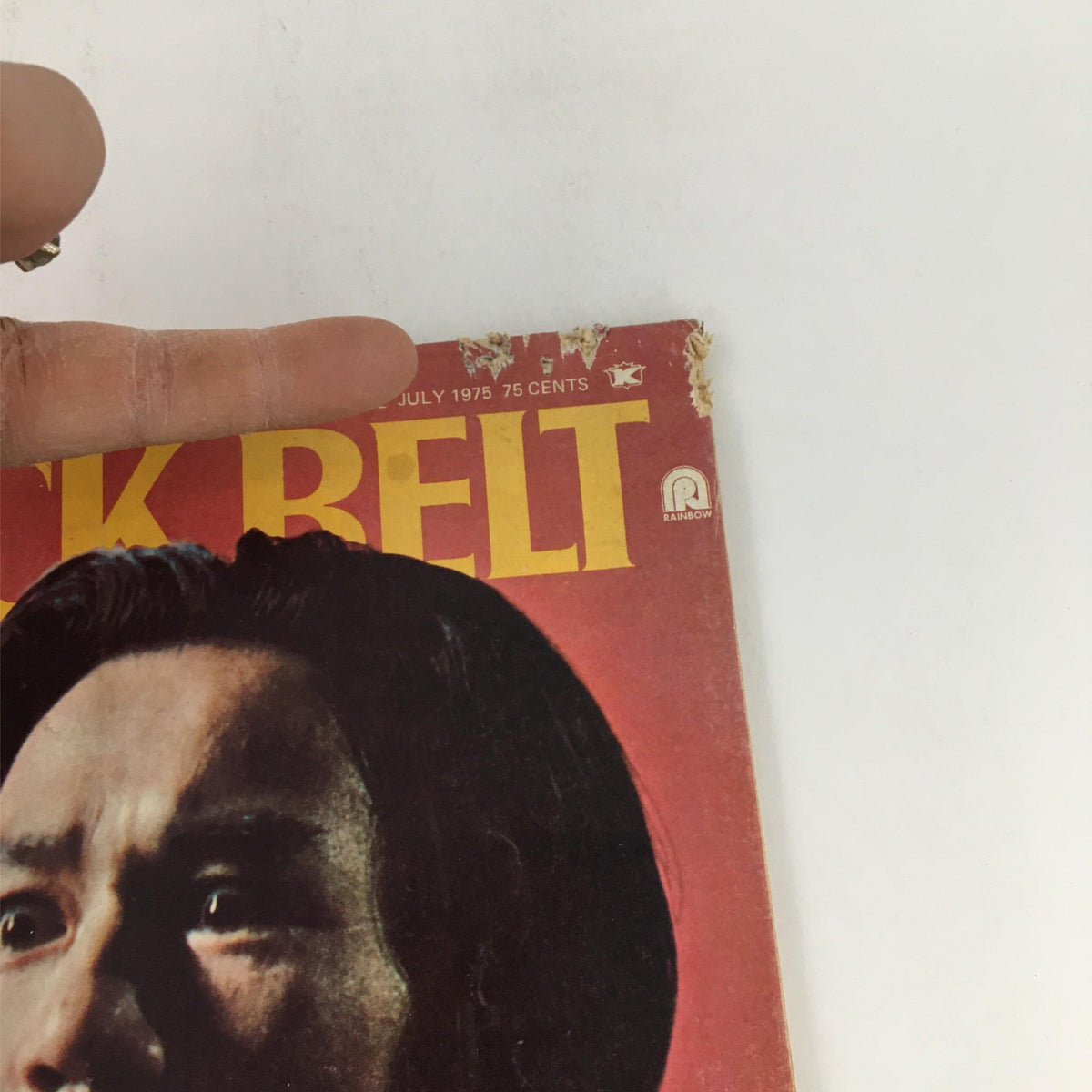 Close-up of the top corner of the Black Belt Magazine July 1975 cover showing wear and tear.