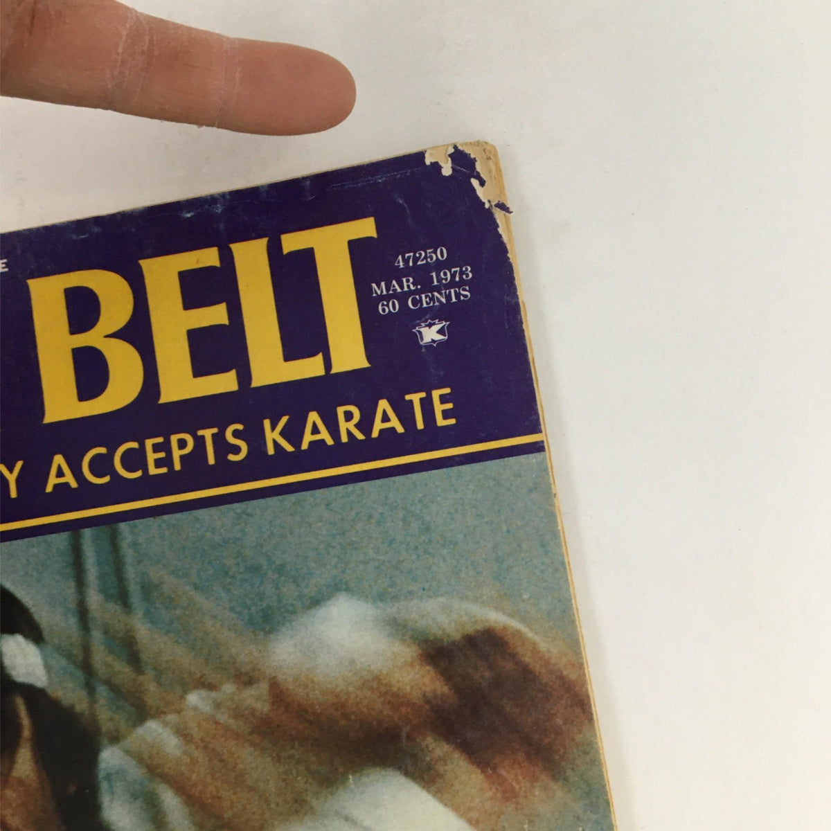 Close-up of the Black Belt Magazine March 1973 cover indicating wear, highlighting the title and details about martial arts.