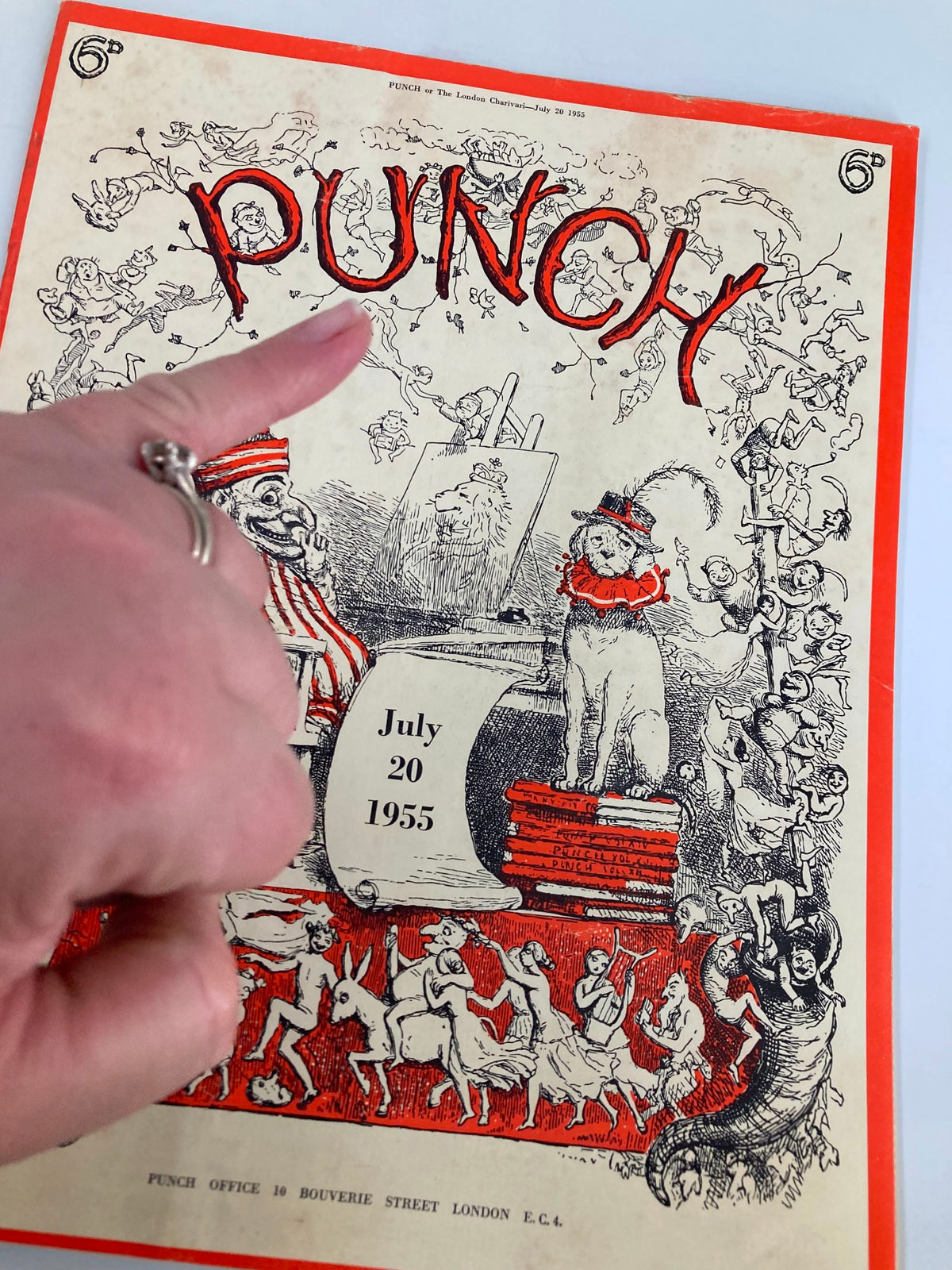 Hand holding VTG Punch Magazine July 20 1955, highlighting its vintage cover with playful illustrations and bold title.