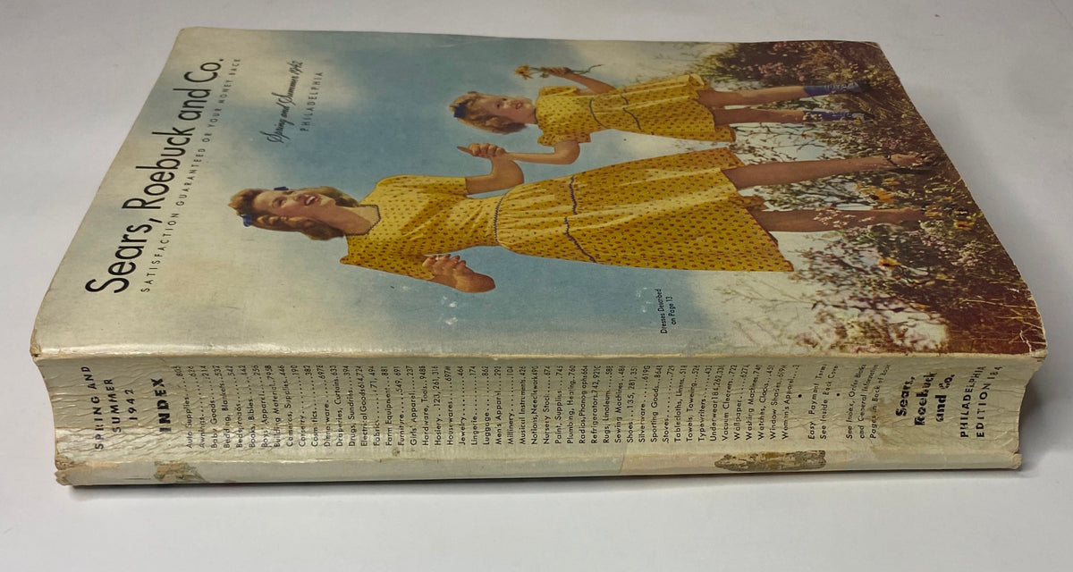 1942 Sears, Roebuck and Co. Spring and Summer Catalog spine view with image featuring a mother and daughter in matching yellow dresses, representing family fashion of the era.