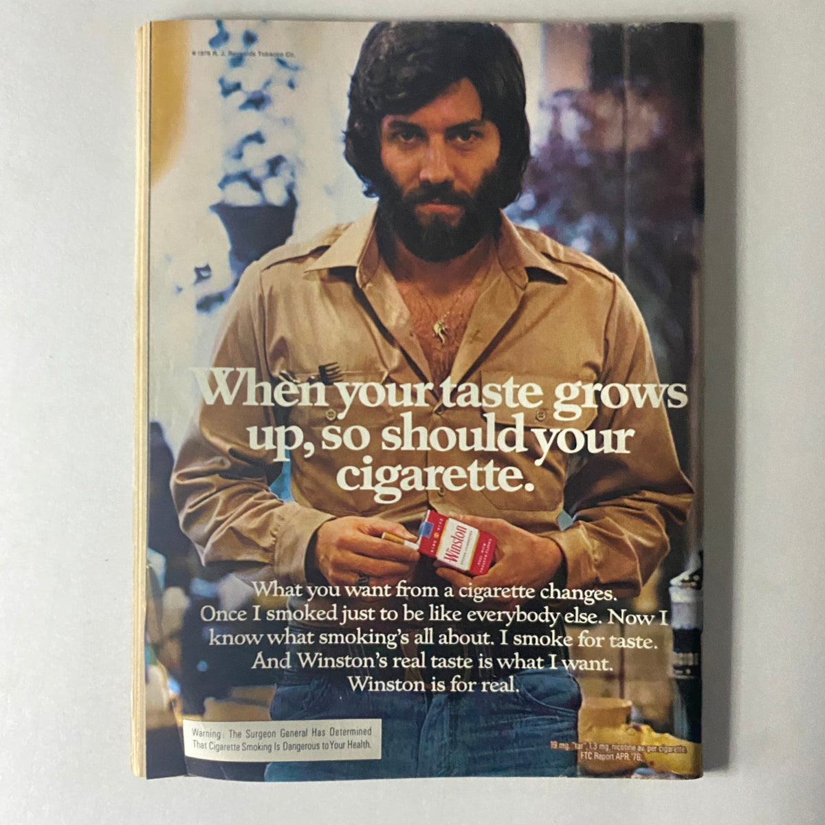 Cycle World Magazine February 1977 vintage advertisement for Winston cigarettes featuring a man in casual attire, promoting the brand's sophisticated appeal.