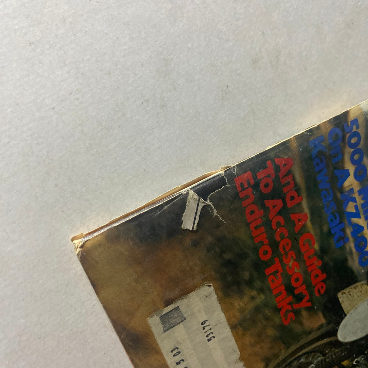 Cover edge of Cycle World Magazine February 1976 featuring Maico 250WR Cross Country, showing minor wear and an old address label.